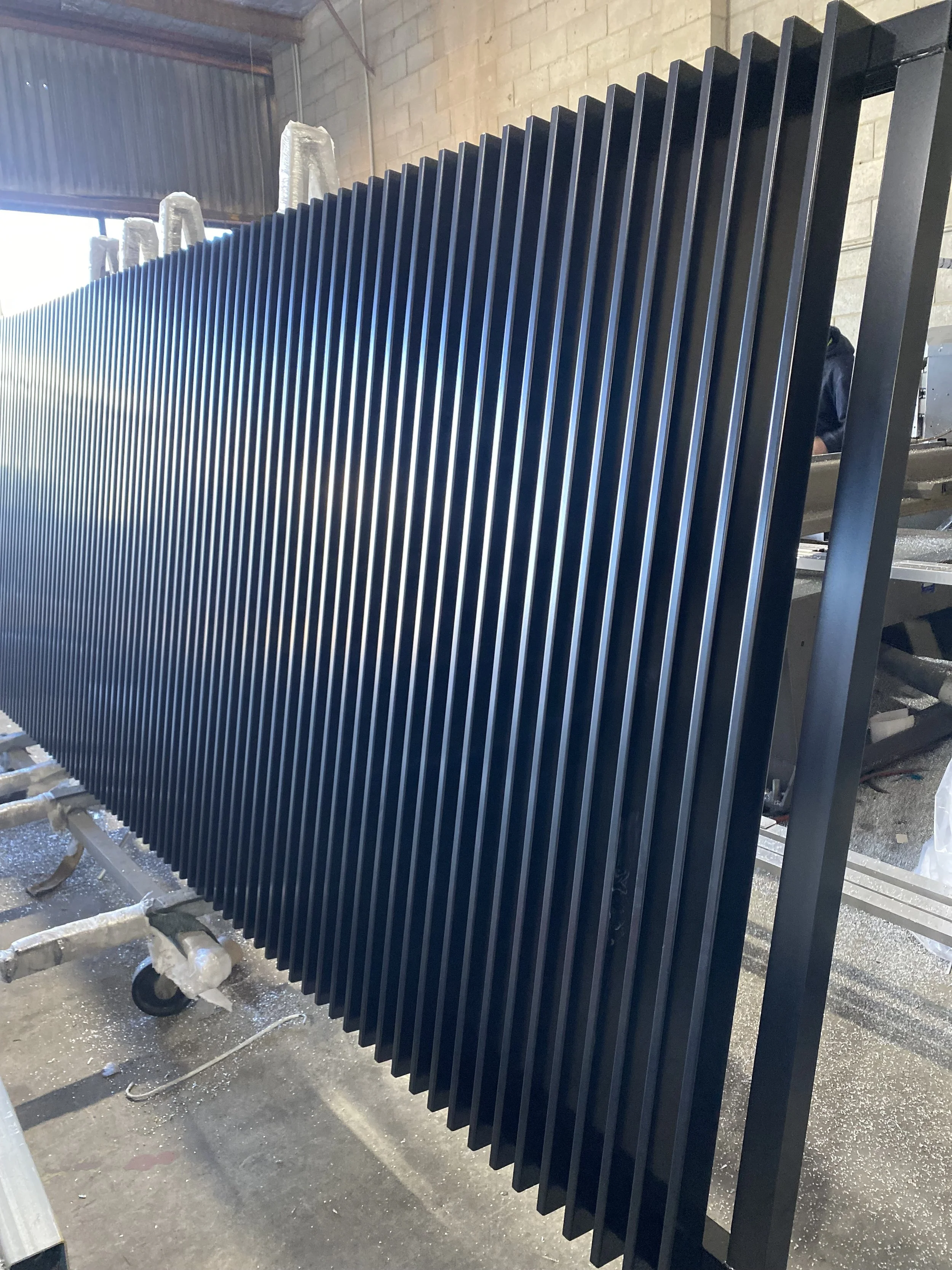 Black batten front gate - manufactured by Swift Powdercoating & Fencing Brisbane
