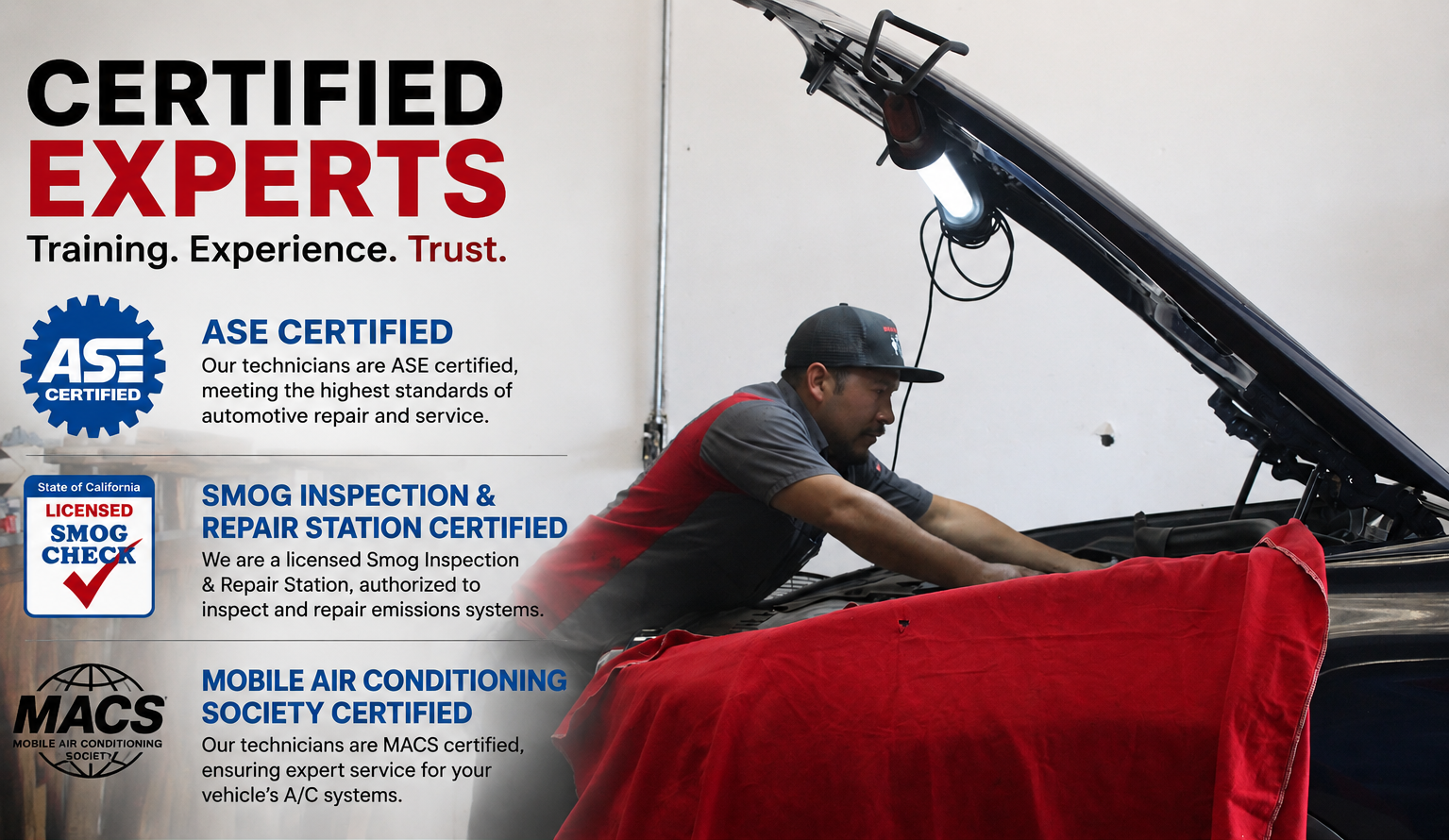 An auto mechanic working on a vehicle with its hood open, wearing a gray and red uniform and a black cap, inside a repair shop with informational posters on the wall.