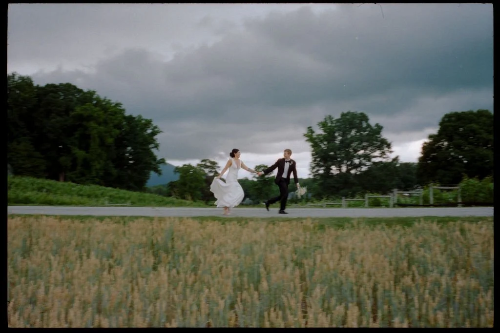 Bride and Groom running from the rain. Captured on film.