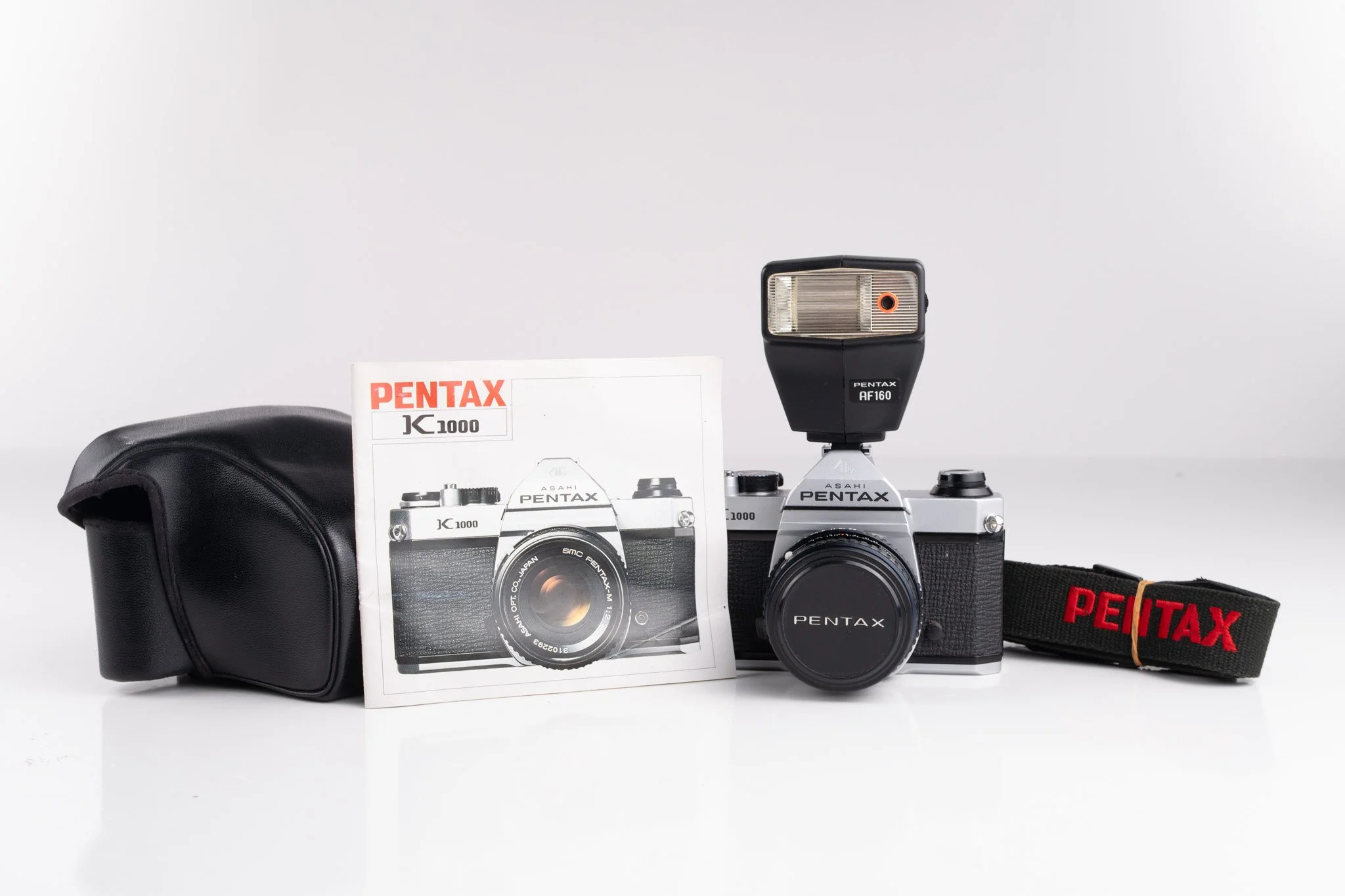 Pentax K1000 35mm film camera, front view with manual