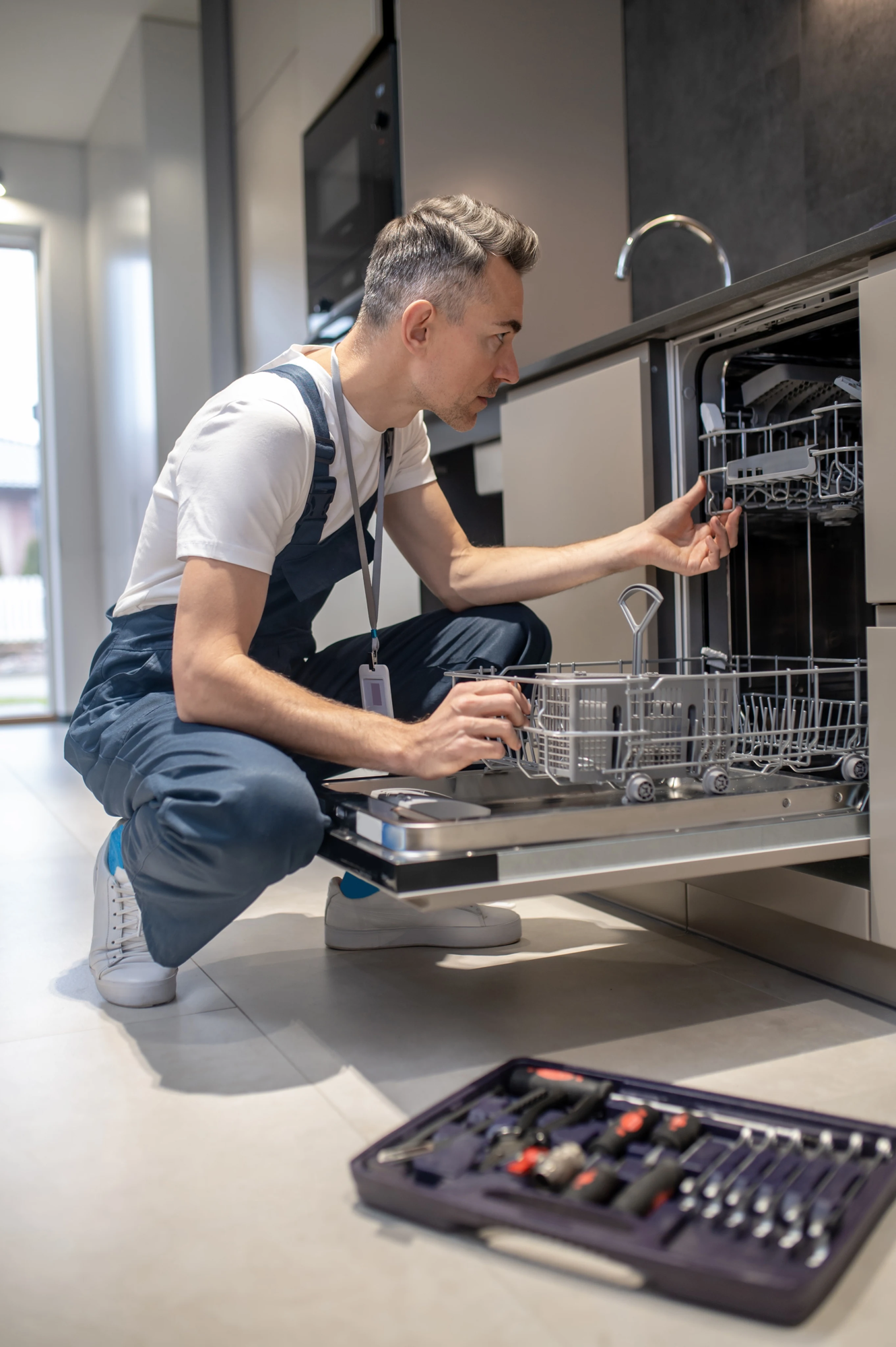 Appliance Repair technician repairing dish washer