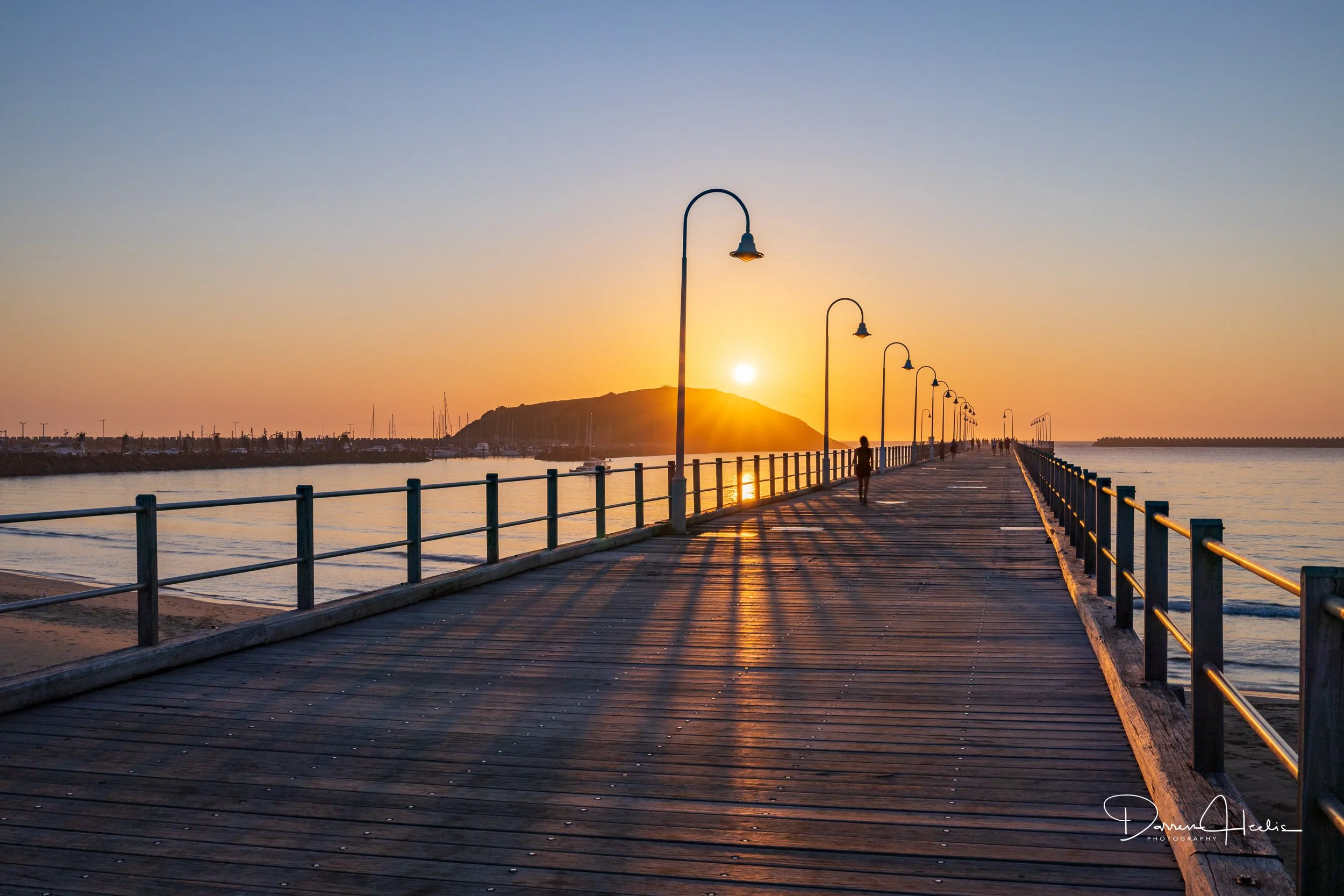 As the first rays of sunlight rise above the Coffs Coast, the iconic Coffs Harbour Jetty i