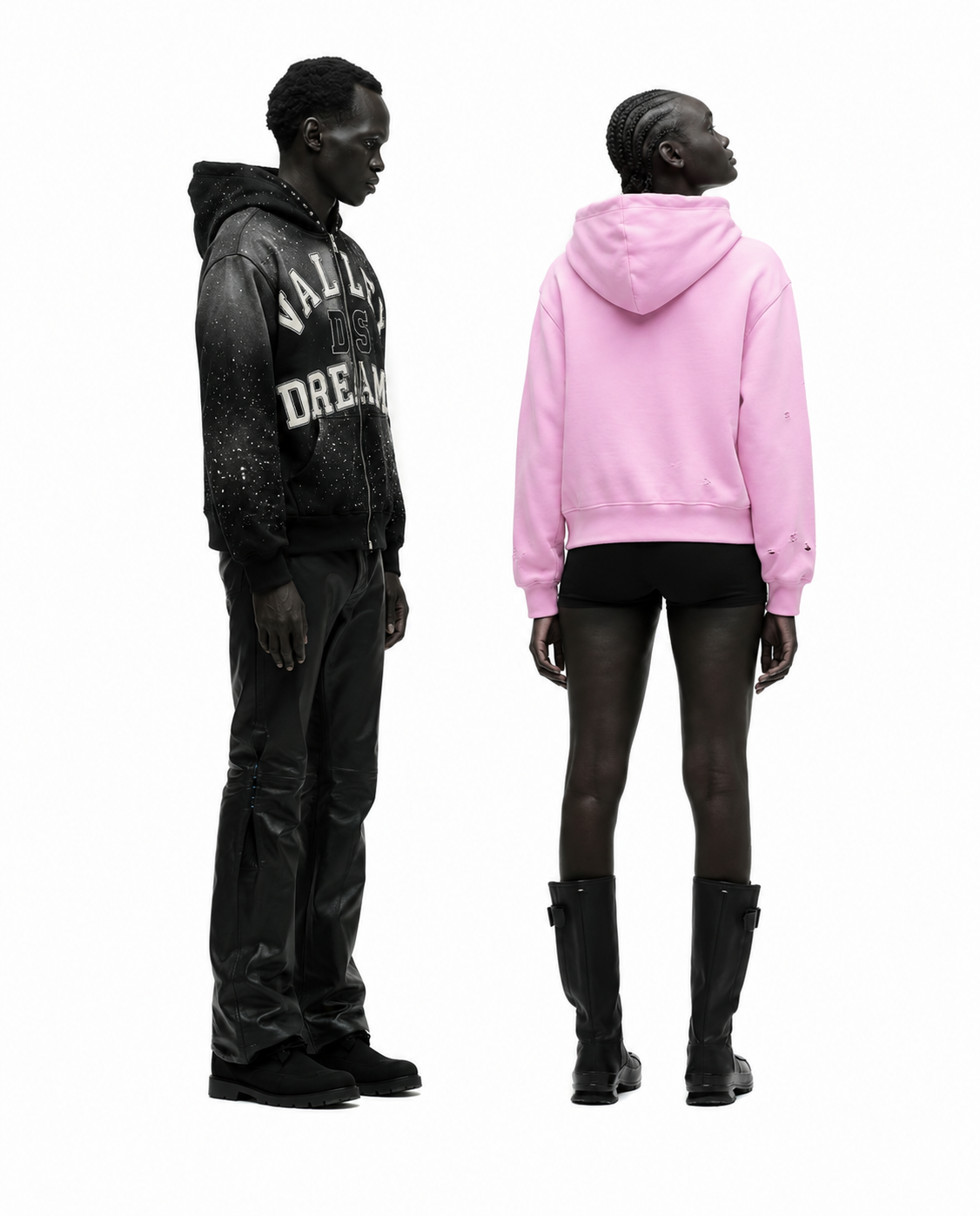 Two Black models, one male and one female, standing against a white background, facing opposite directions, wearing casual streetwear.