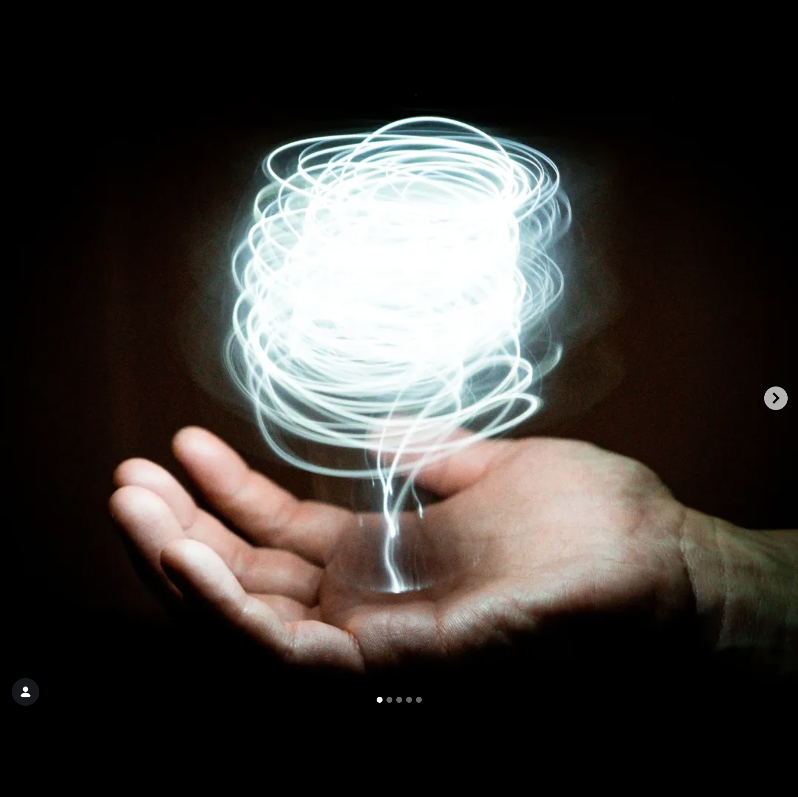 Photo of a hand with light spiralling out of it