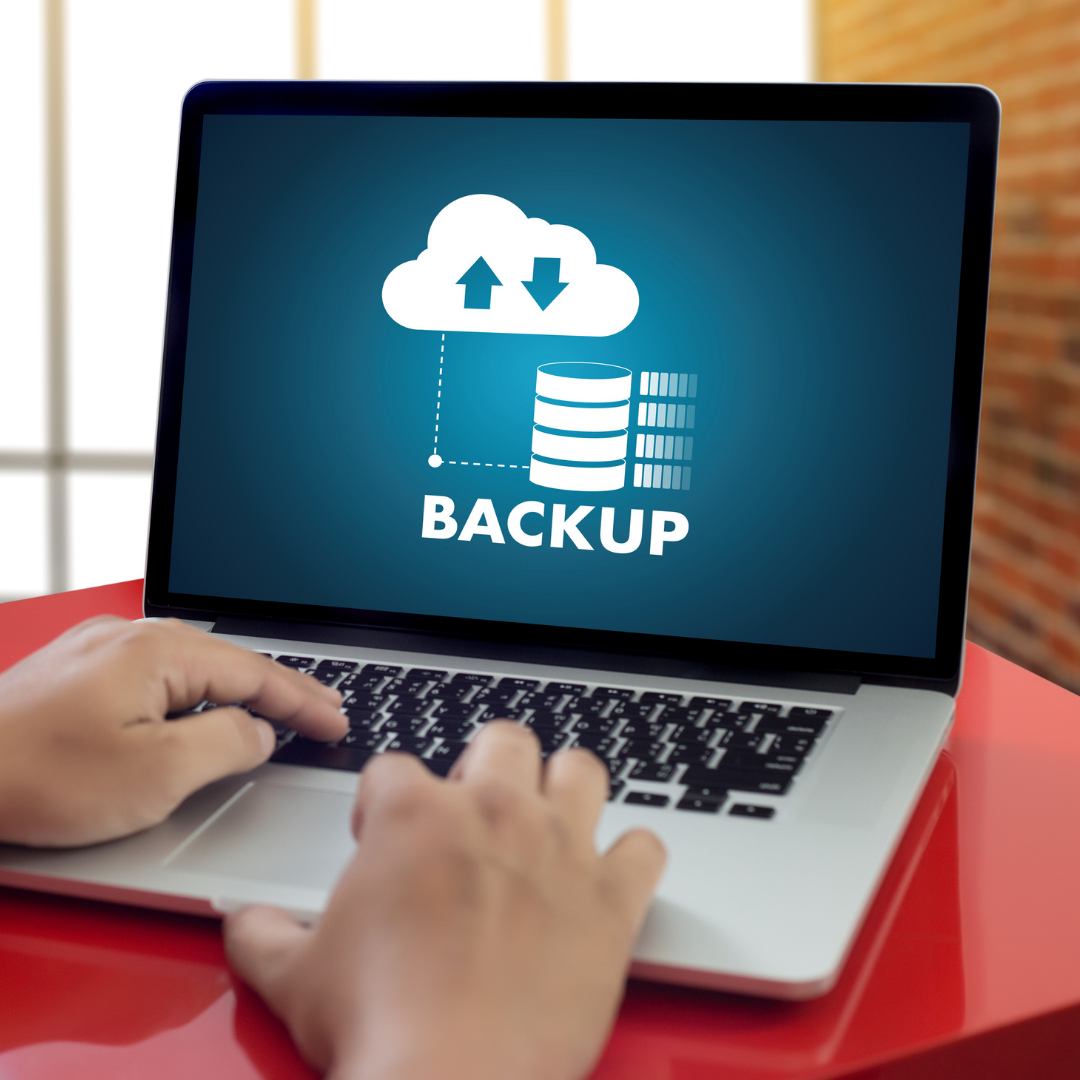 Laptop screen displaying a cloud icon with upload and download arrows and the word 'BACKUP' with a database symbol.