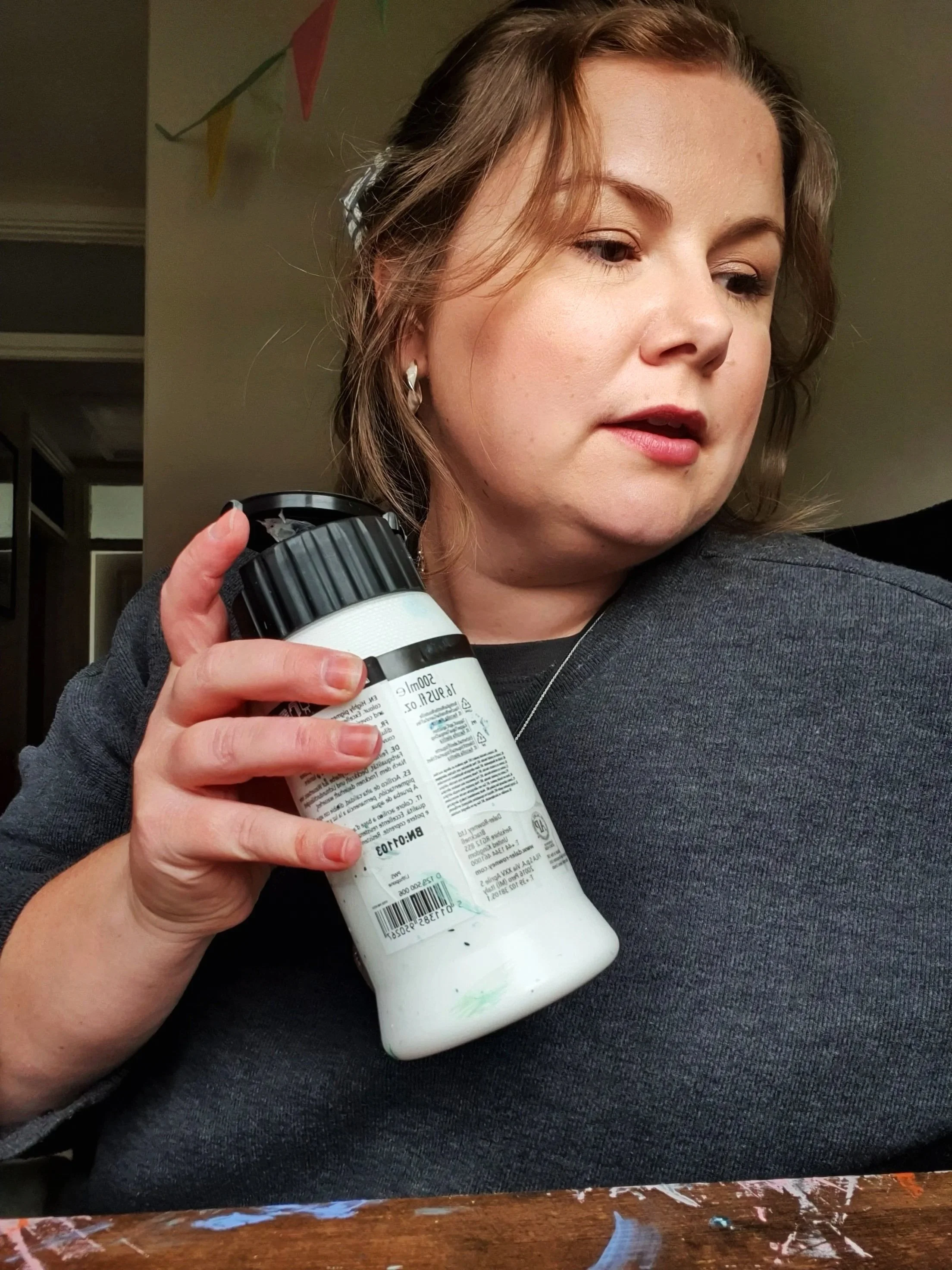 Artist Alice Chapma organising paints in her studio in Cheltenham, Gloucestershire.