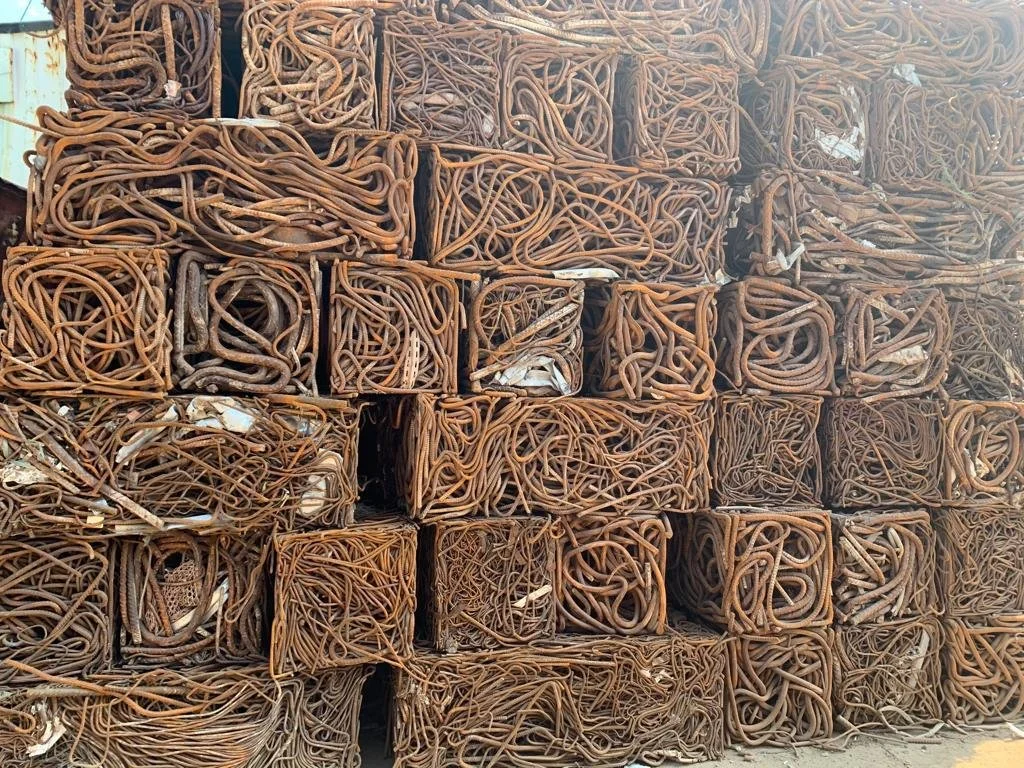 A stack of coiled rusted metal wires arranged in rectangular blocks.