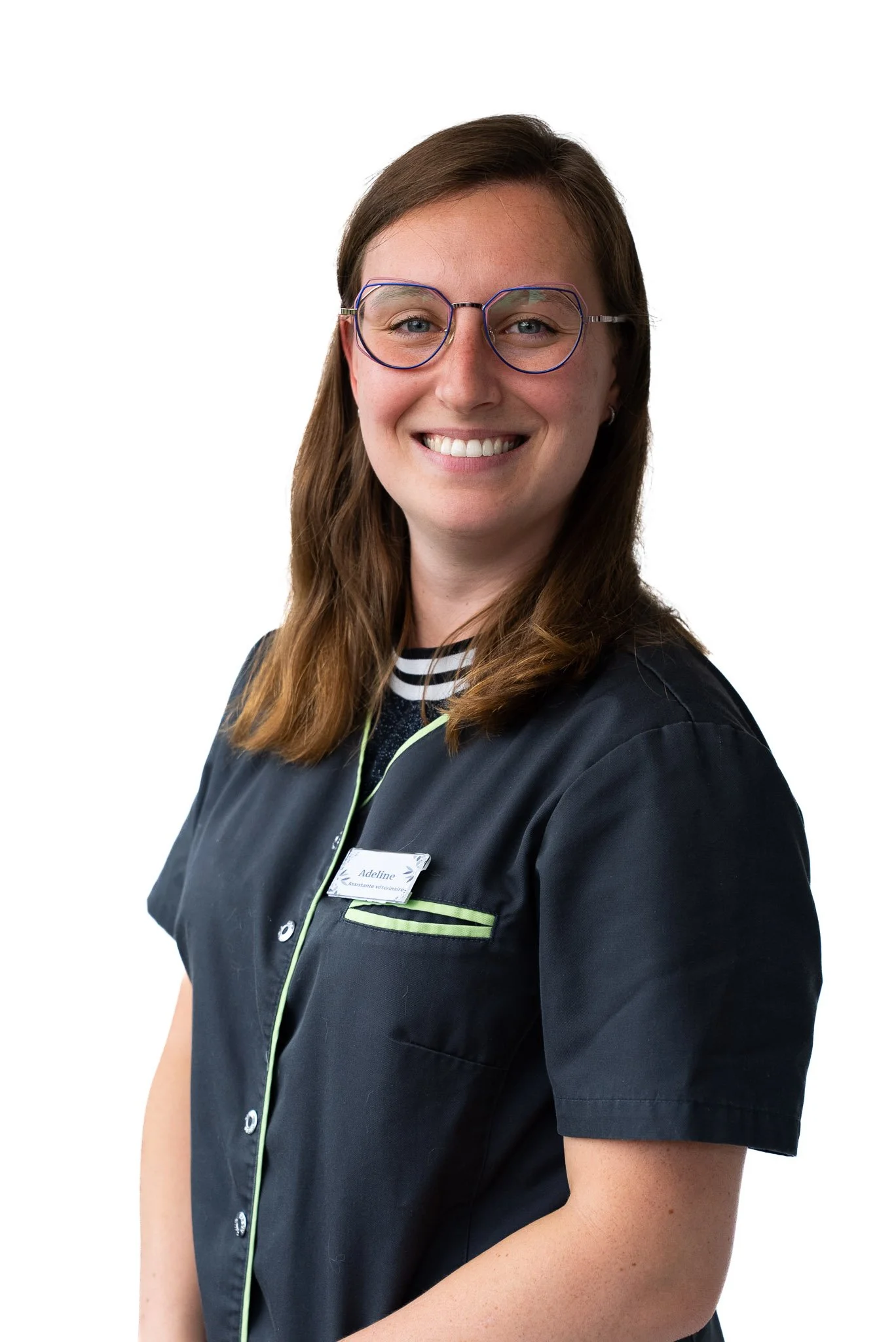 Staff member in blue medical scrubs, smiling, white background.