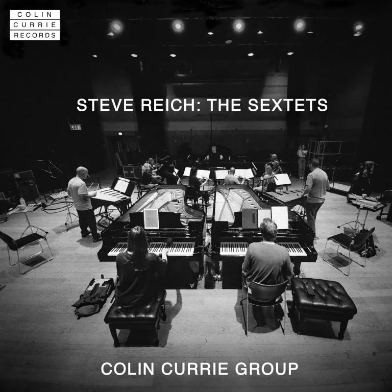 A black and white photo of a group of musicians rehearsing on stage with pianos and other instruments, titled 'Steve Reich: The Sextets' performed by the Colin Currie Group.