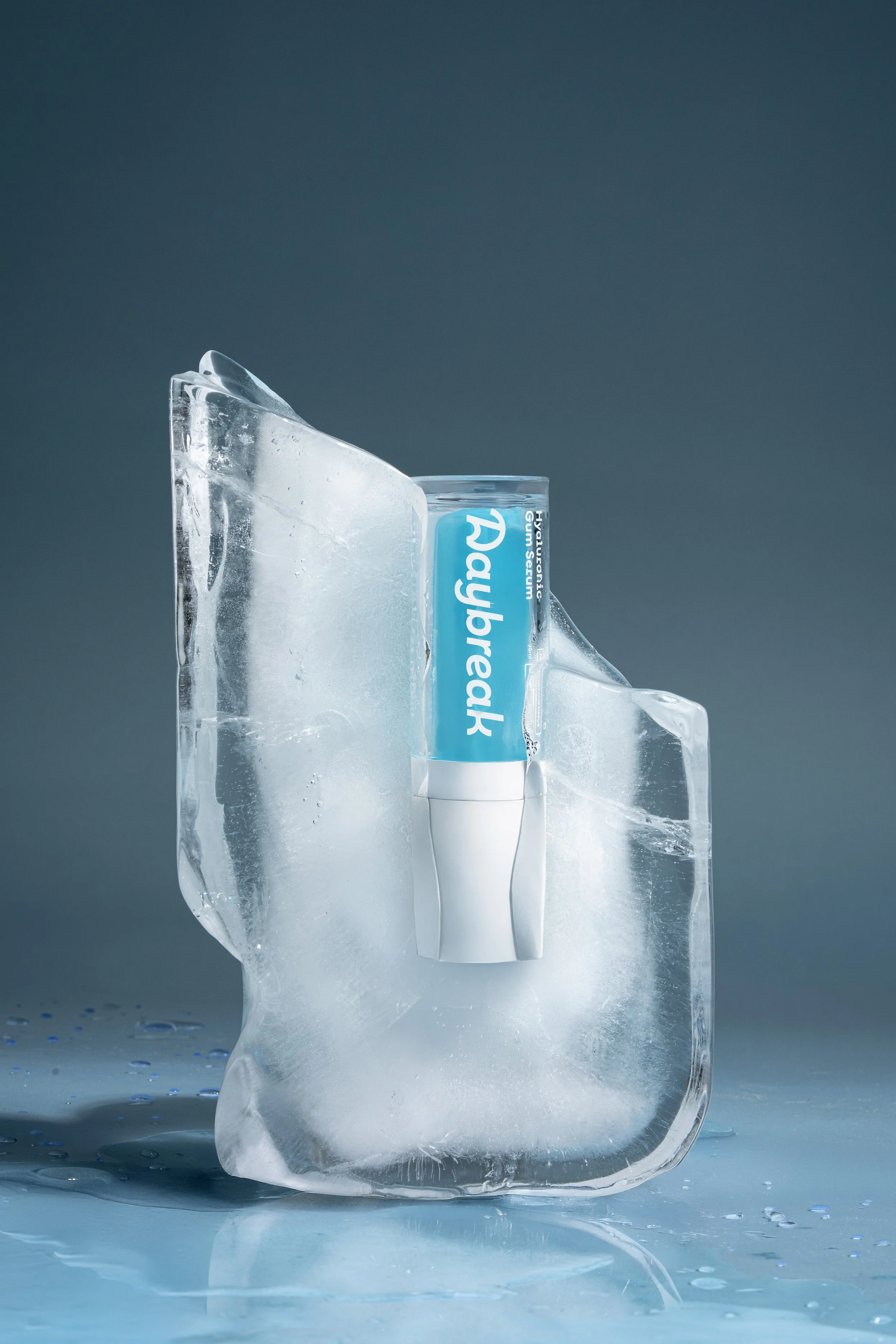 A tube of Aquaphor moisturizer inside a block of ice.