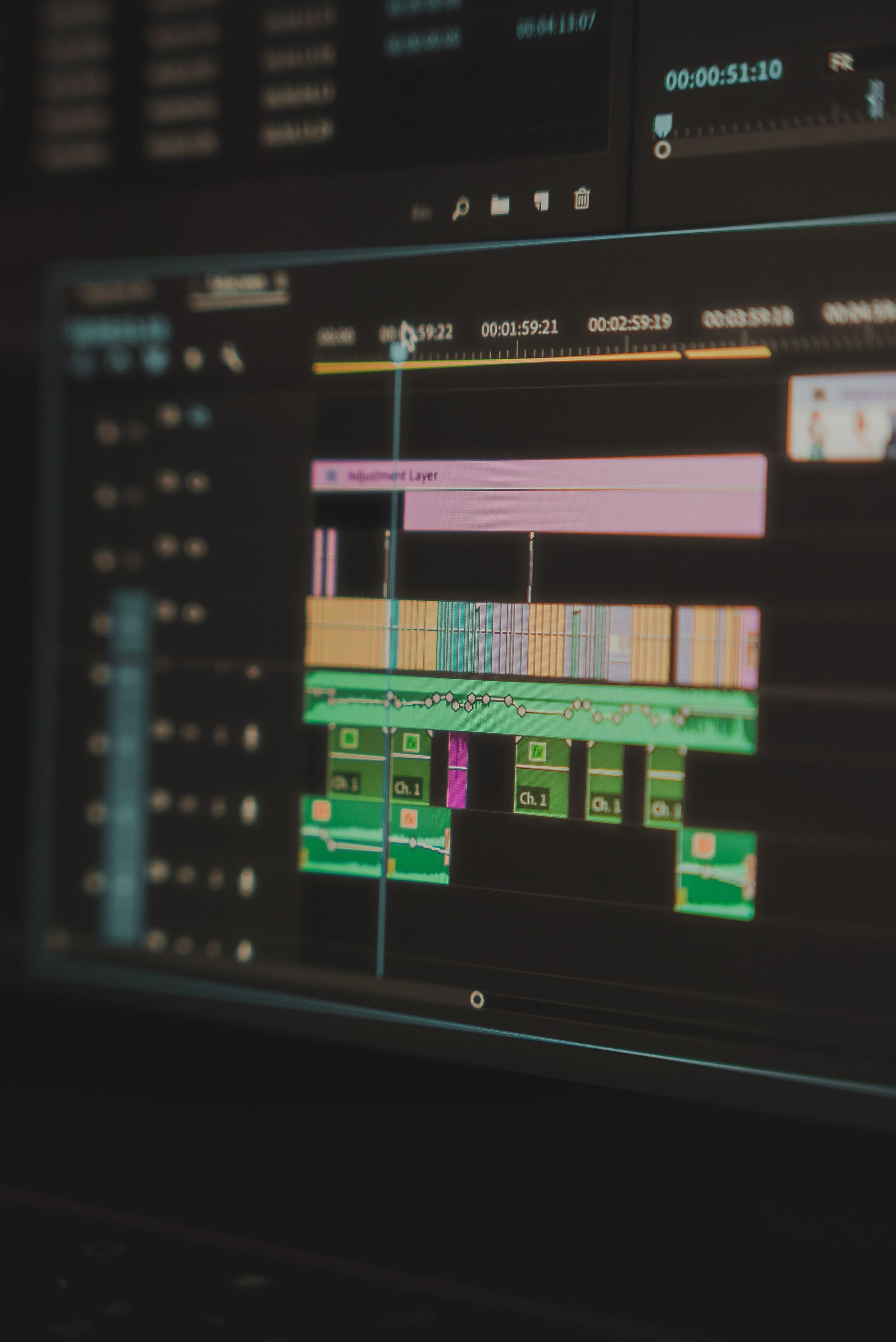Screenshot of video editing software with multiple tracks, timeline, and color-coded clips.