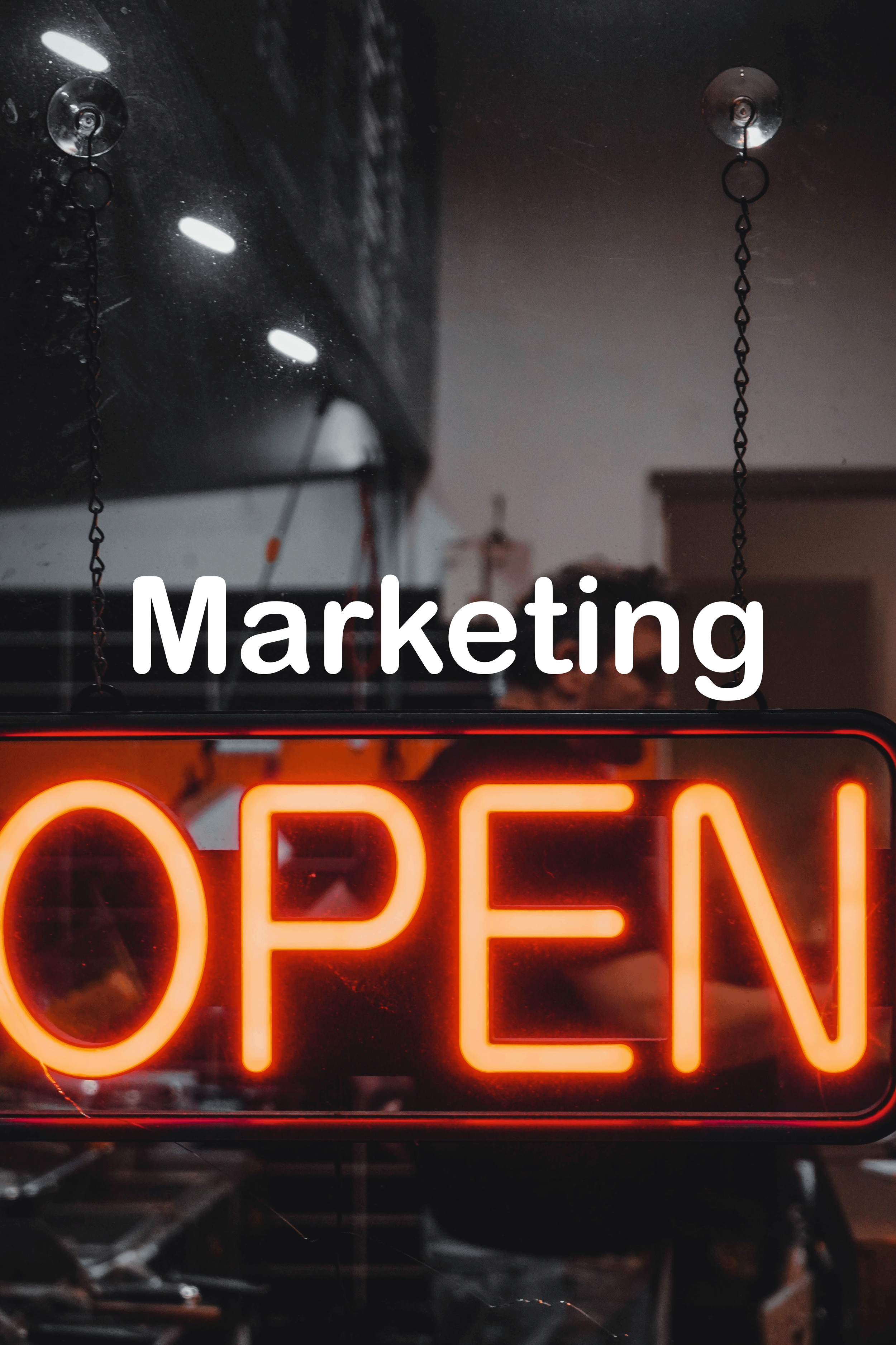 A neon open sign in a dark setting with the word 'OPEN' illuminated in bright orange, partially visible at the bottom of the image.