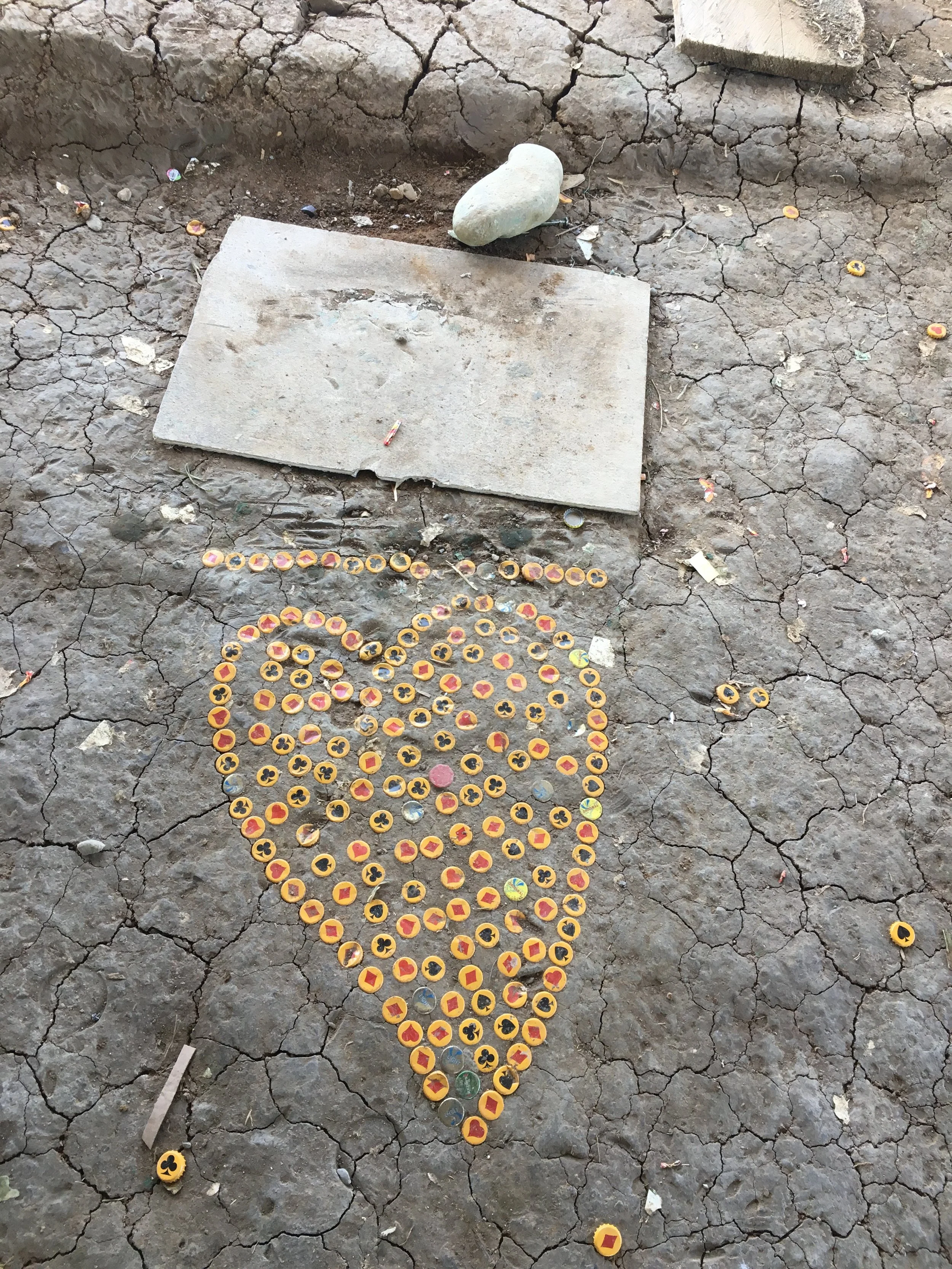 Beer bottle caps are arranged into the shape of a heart in a transition zone for former combatants leaving armed groups in Colombia.