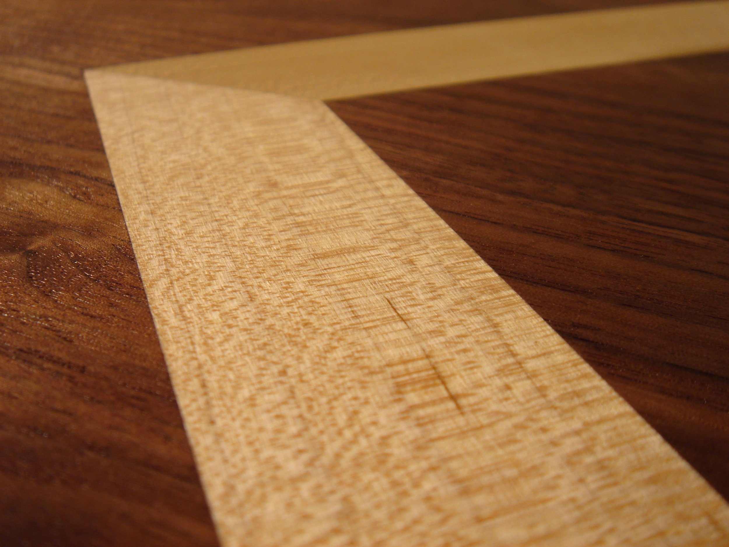 Close-up of a strip of masking tape on a wooden surface.
