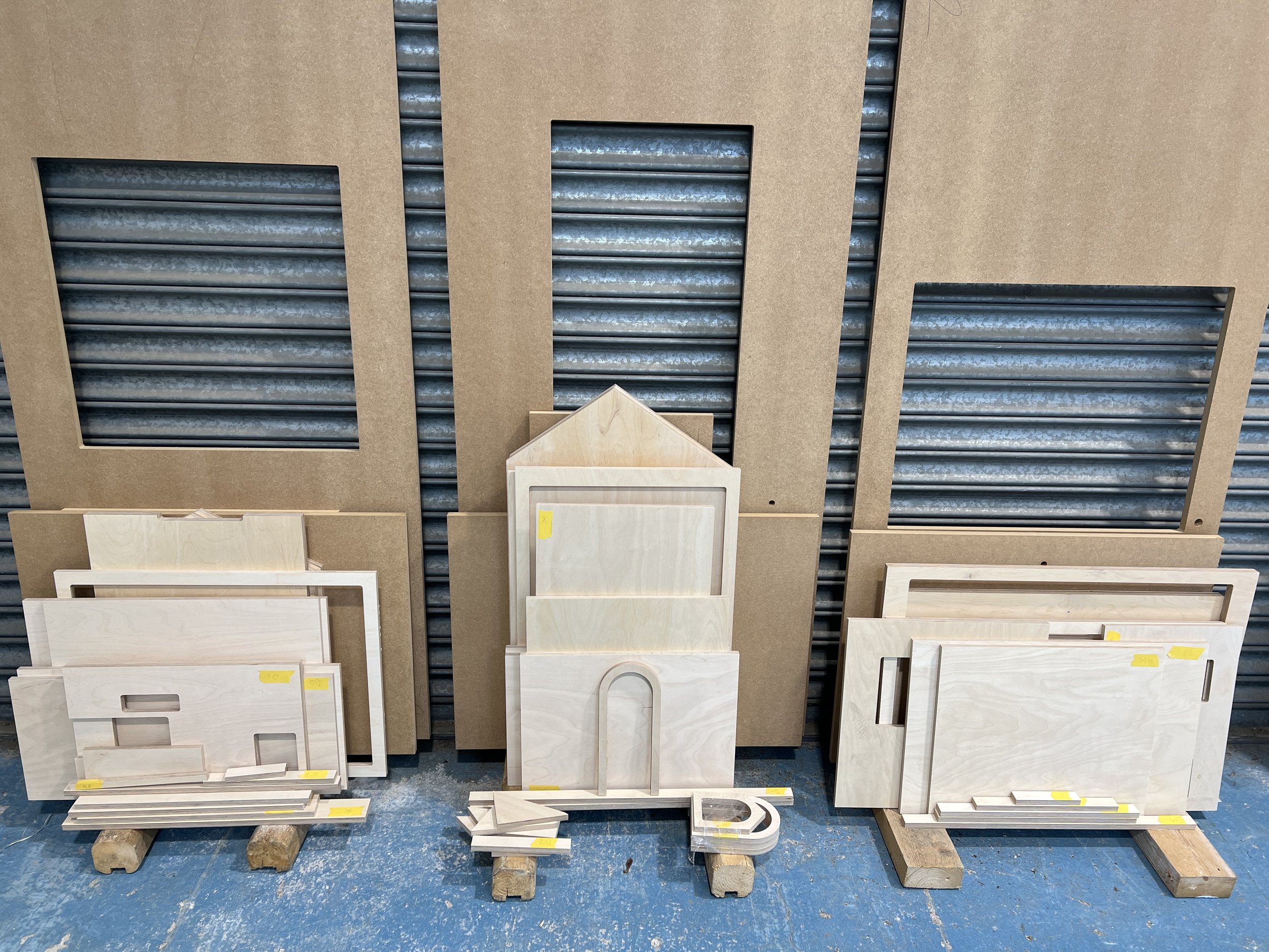 Display of various cabinet or drawer front panels in different styles and finishes on a store shelf.