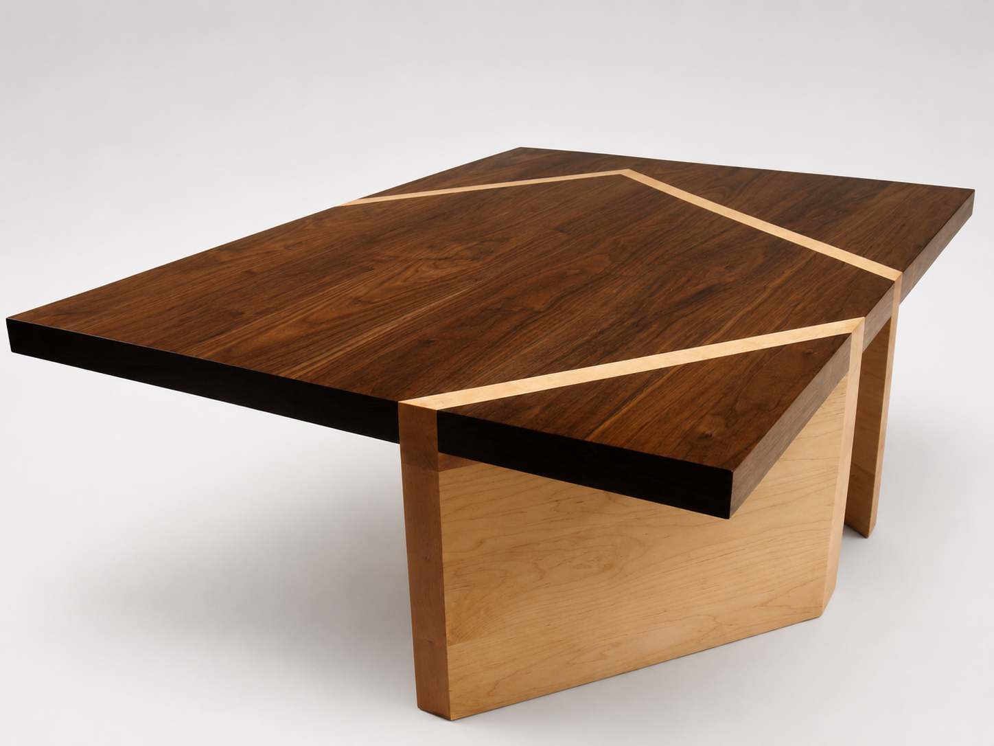 A modern wooden table with a unique geometric design, featuring a dark wood top and light wood accents and base.