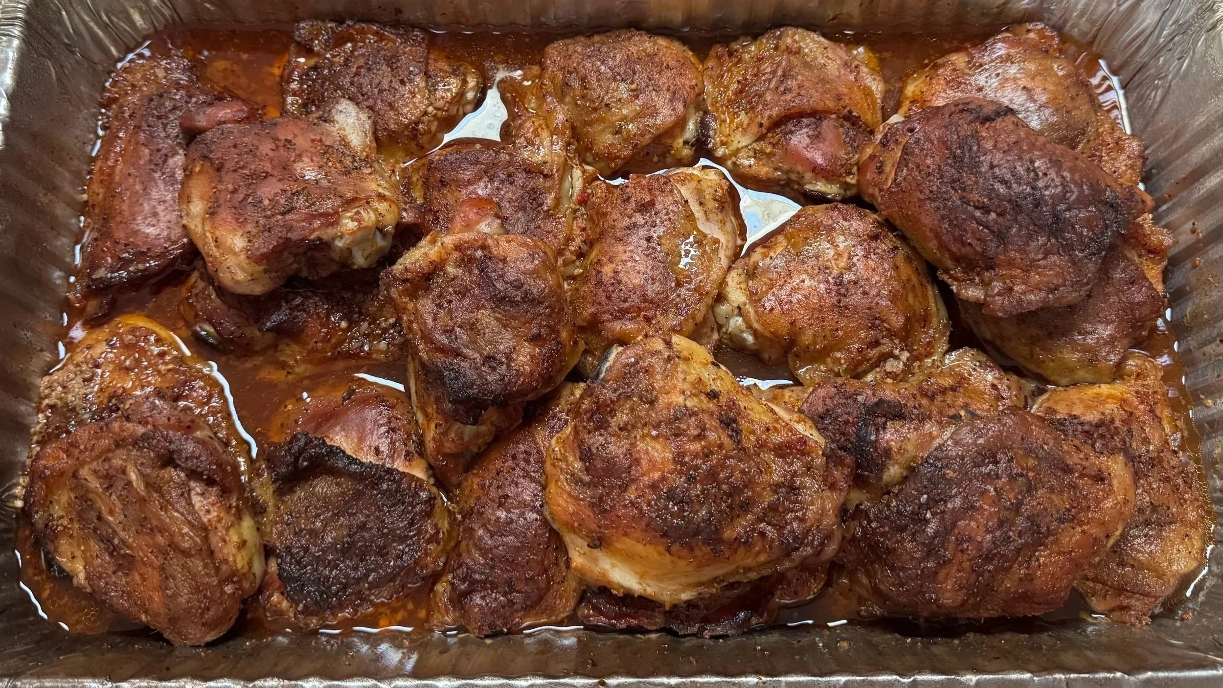 Cooked seasoned chicken pieces in a baking dish