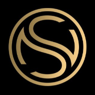 A circular logo with a gold and black color scheme, featuring intertwined initials S and G.