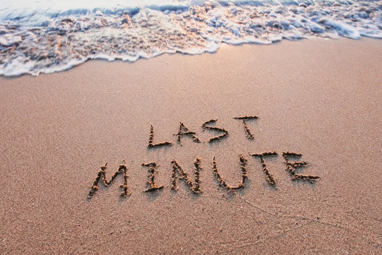 Last minute holidays written in the sand