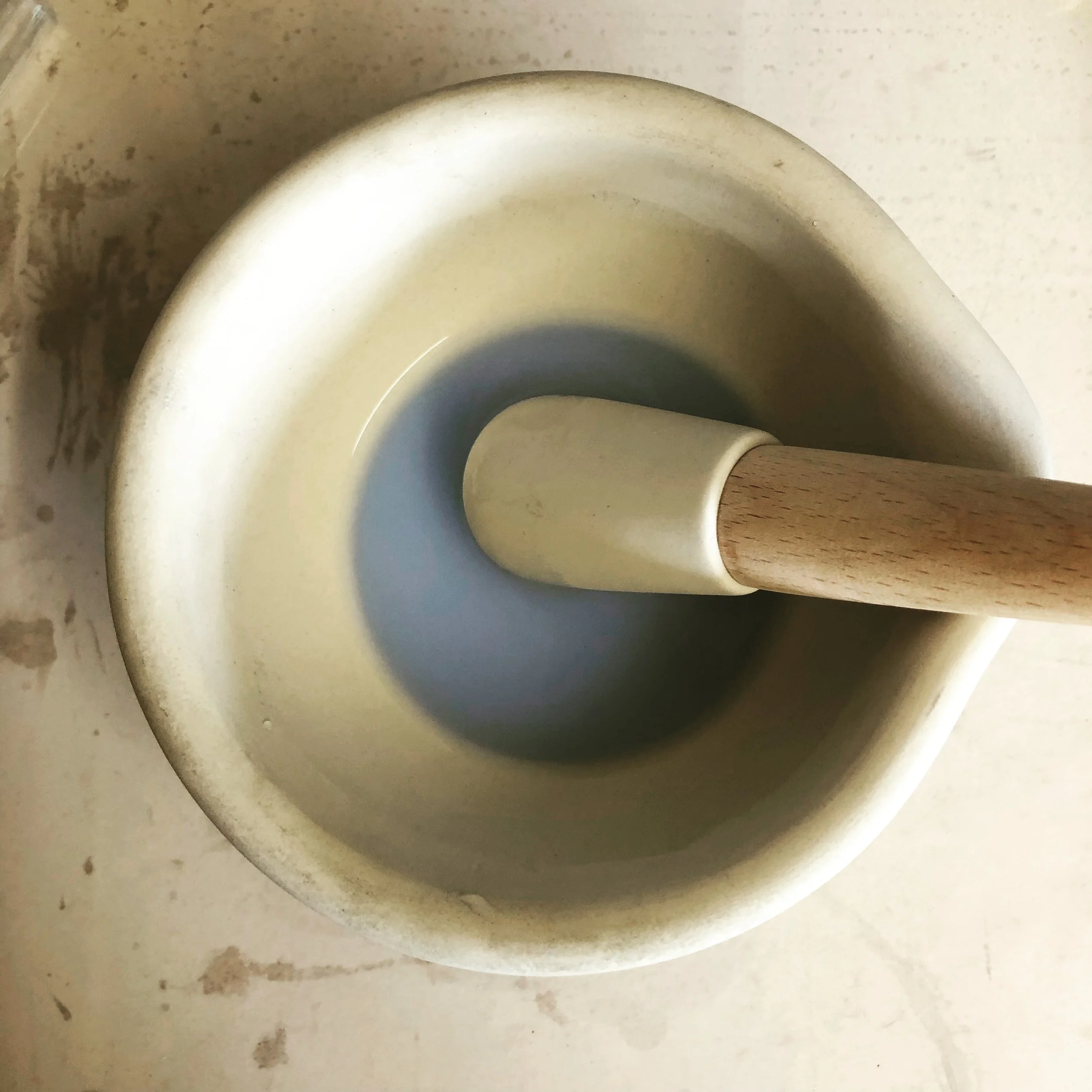White ceramic mortar and pestle with enamel.