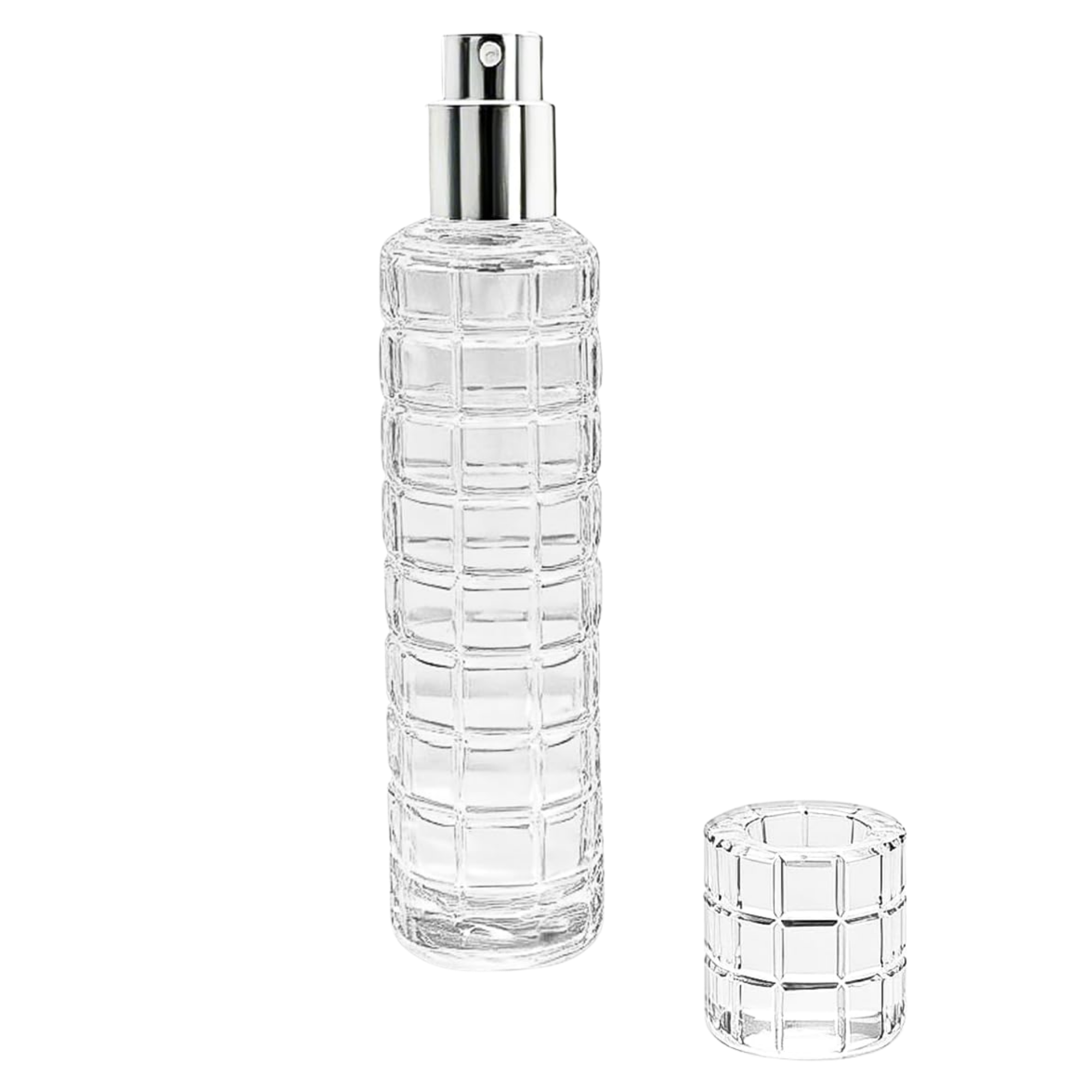 A clear glass spray bottle with a shiny silver pump, next to a matching cap.