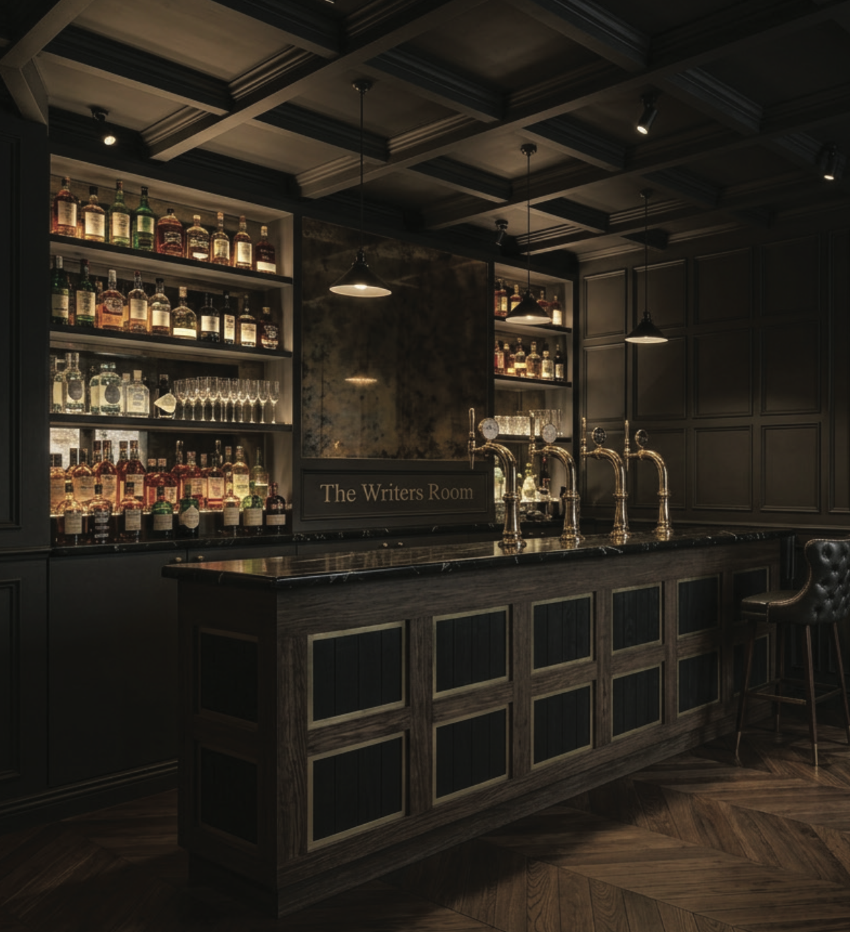 A dark, elegant bar area with a wooden counter, multiple liquor bottles on shelves, brass beer taps, and a sign that reads 'The Writers Room'.