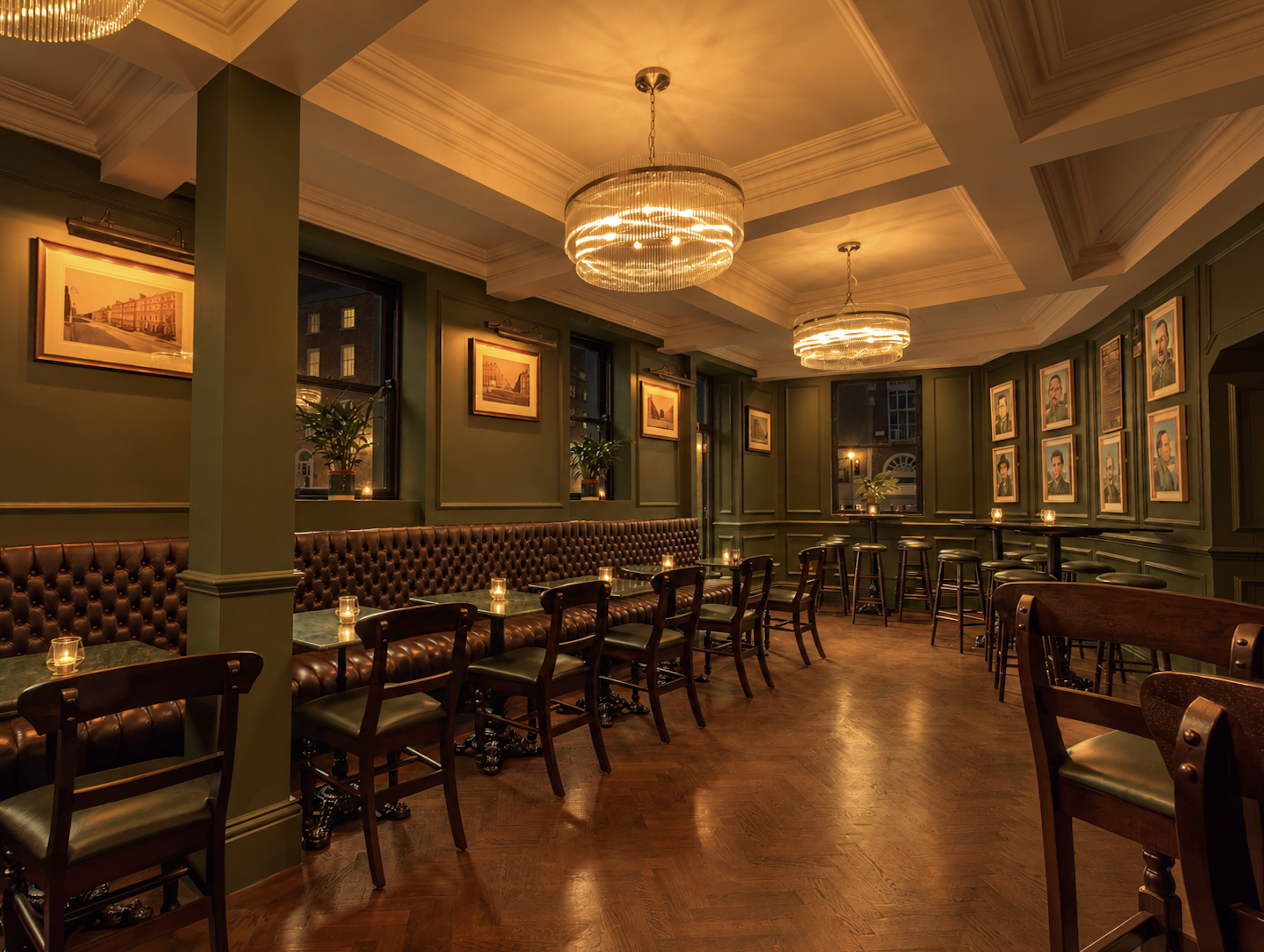 Elegant vintage restaurant interior with leather banquettes, candlelit tables, framed artwork, and crystal chandeliers