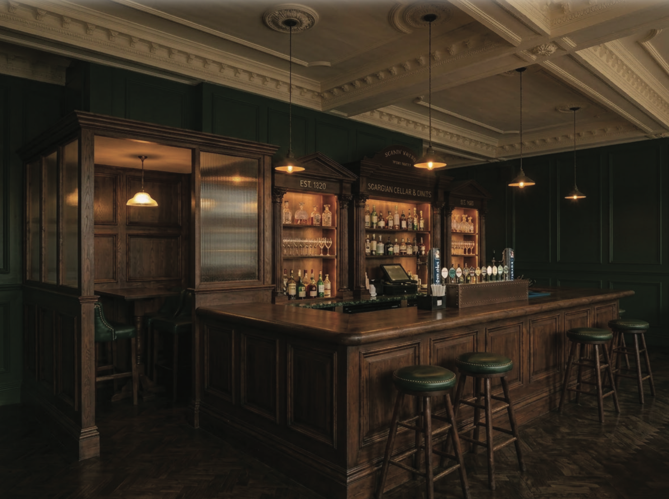 A wooden bar with a dark green wall, hanging pendant lights, and shelves with bottles, glasses, and a cash register.