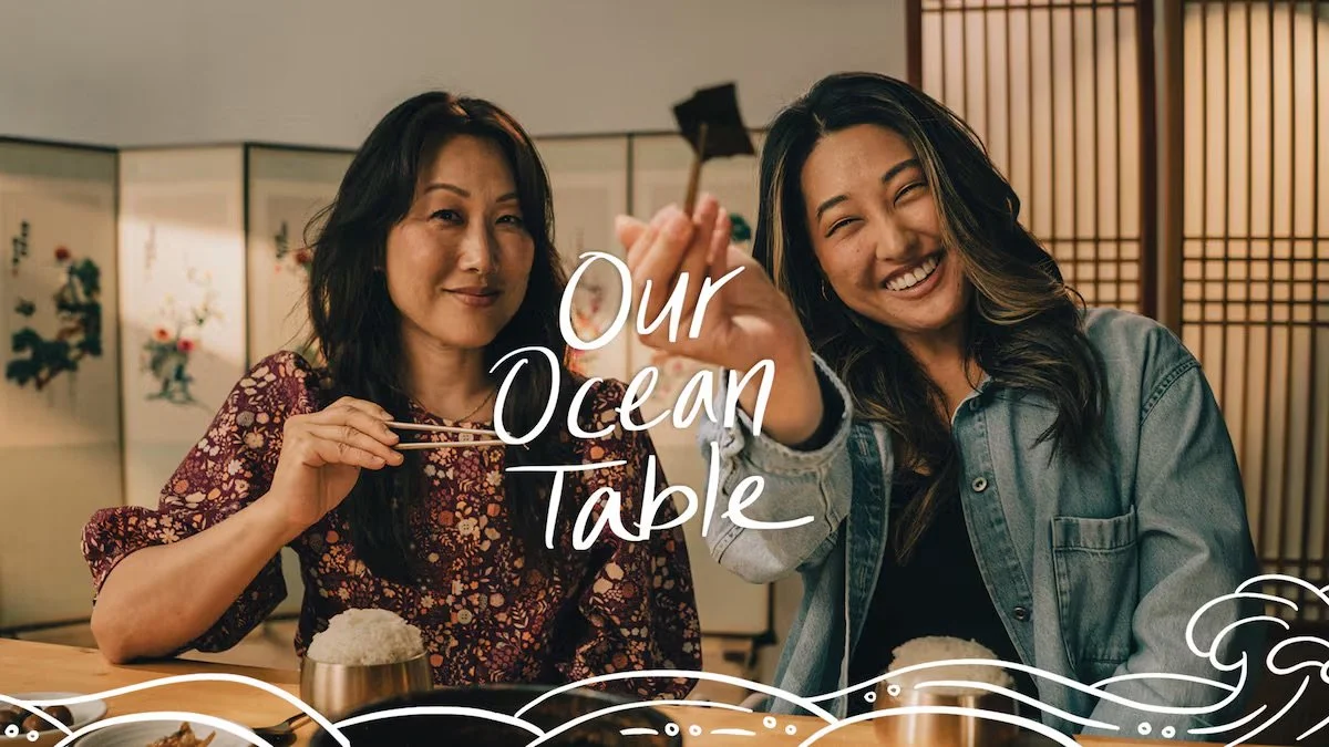 Hannah Sung and Sonya Lee at a dining table in a restaurant, with the text 'Our Ocean Table' overlayed.