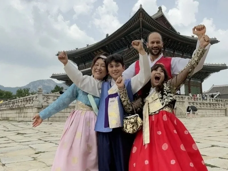 Group of four people celebrating and smiling.