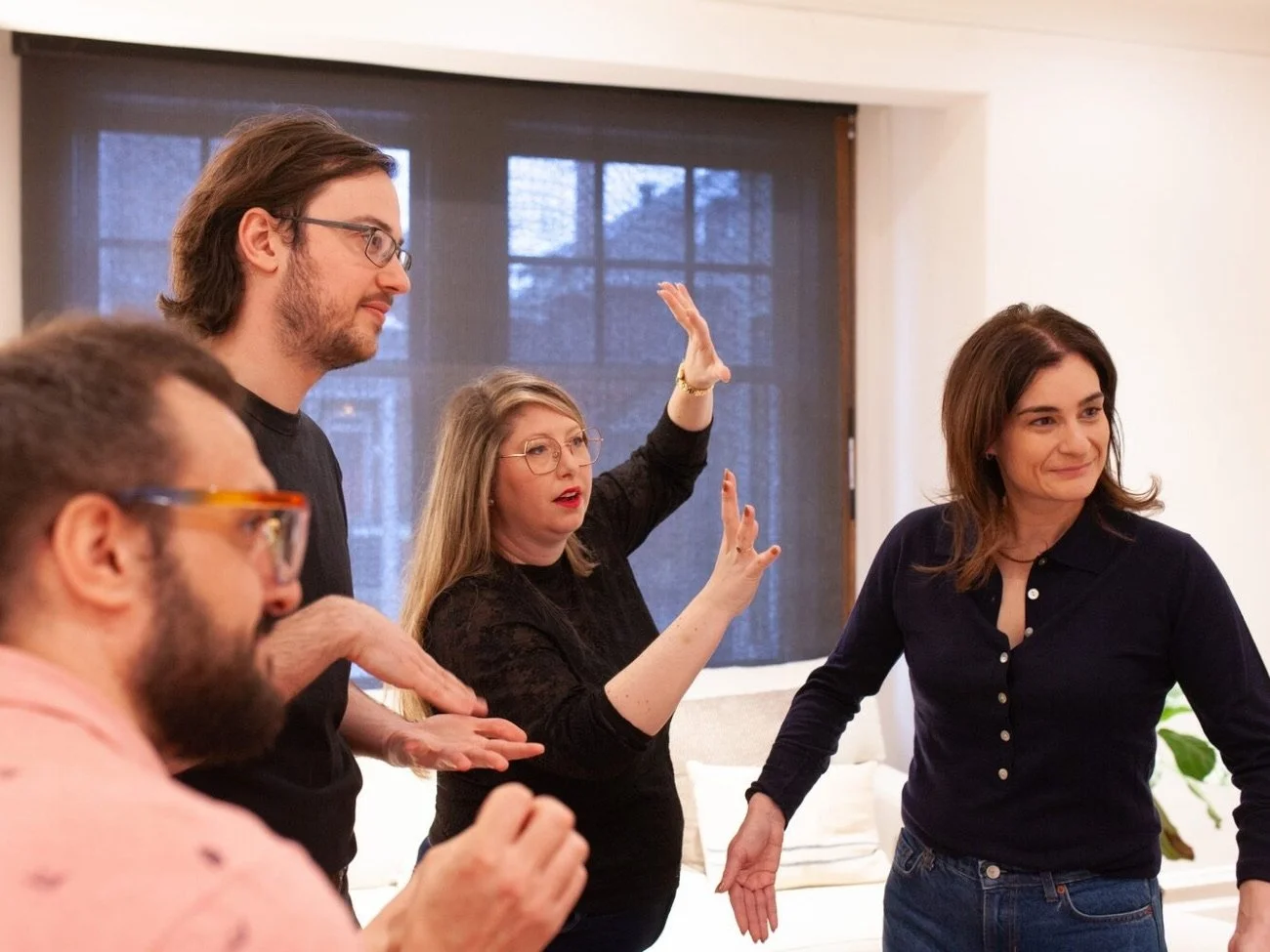 Four people inside a room having a conversation.