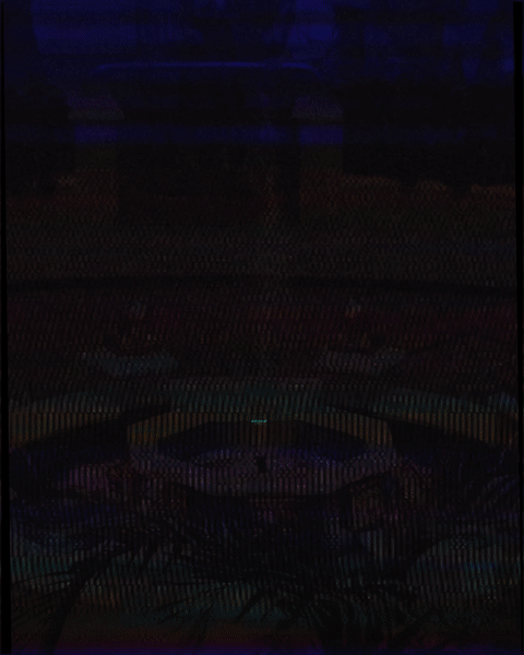 Dark image with faint reflections and unclear objects, making it difficult to identify specific items.