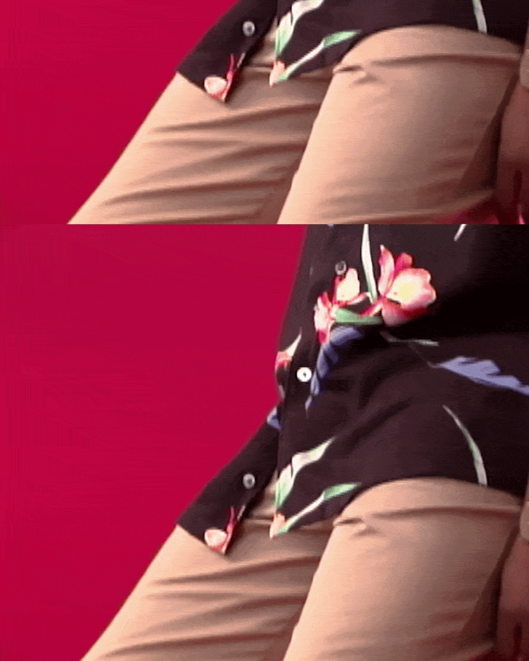 Close-up of a person's lap wearing beige pants and a black floral shirt with pink and green flowers, sitting against a red background.