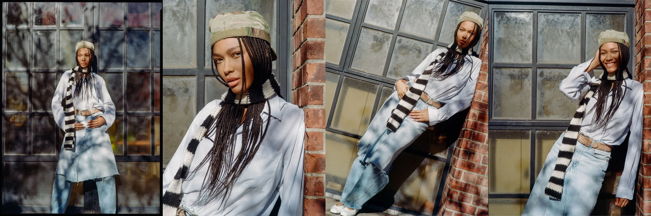 A young woman with long braided hair posing outdoors in front of large industrial-style windows and a brick wall in sunny weather. She is wearing a white button-up shirt, a striped scarf, light-wash jeans, a belt, and a camouflage cap. She is smiling and looking at the camera in some images, and leaning against the wall in others.