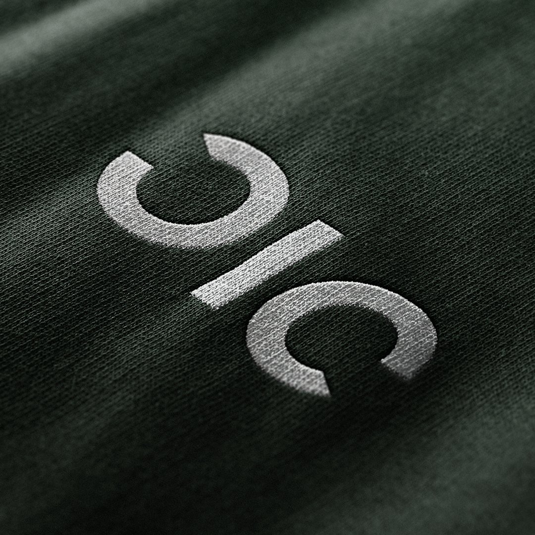 Close-up of a black fabric surface with the brand logo 'Giq' printed in white.