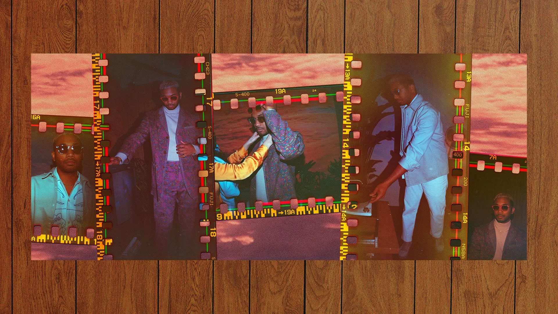 A collection of photo slides featuring men in stylish clothing, with sunset backgrounds over water, laid out on a wooden floor.