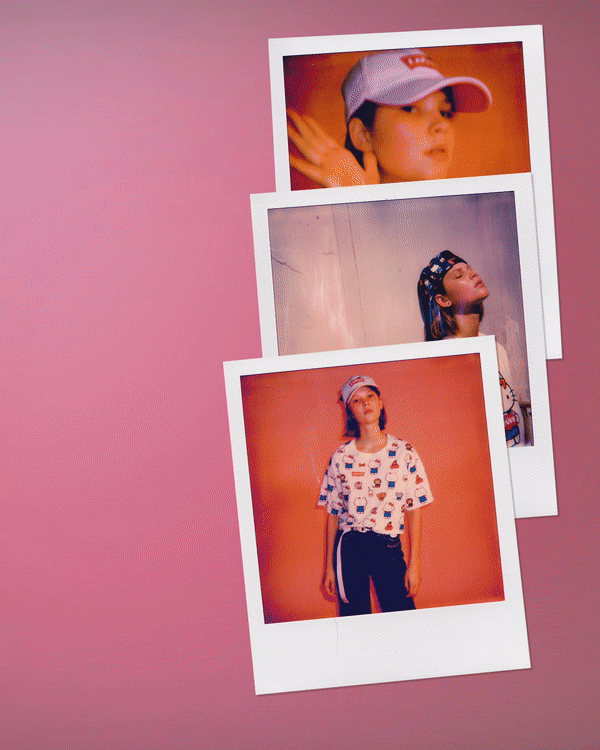 Three instant photos of a young girl, each with different poses and outfits, arranged on a pink background.