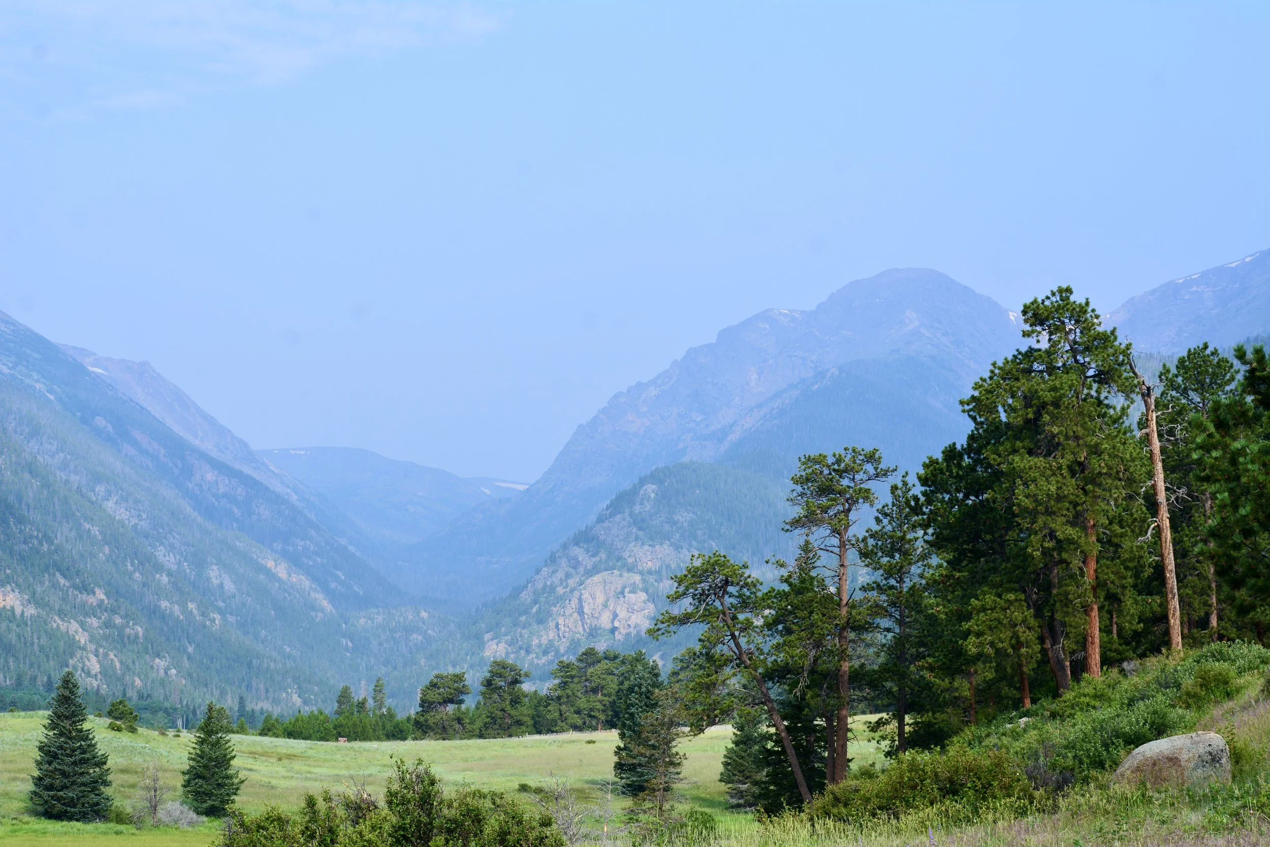 A grand vista of Rocky Mountain National Park is shown showing that it is a great spot for mountain senior portraits in Colorado.