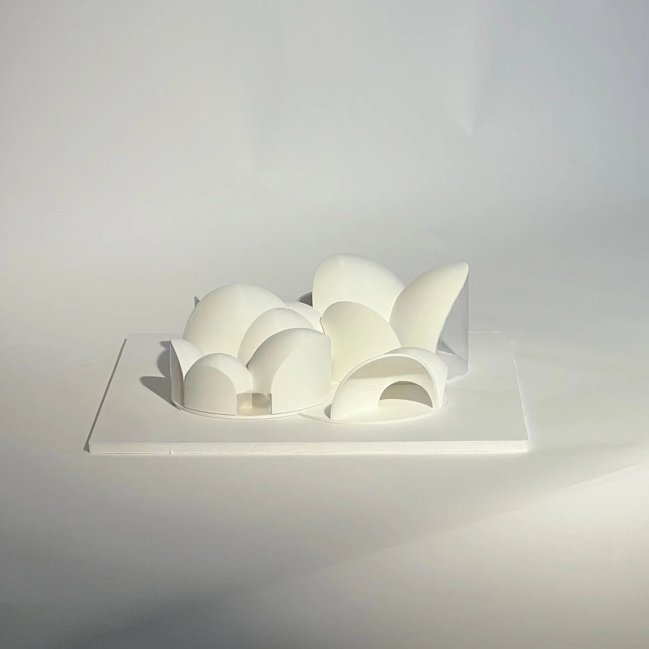 Physical architectural model exploring curved forms and spatial composition.