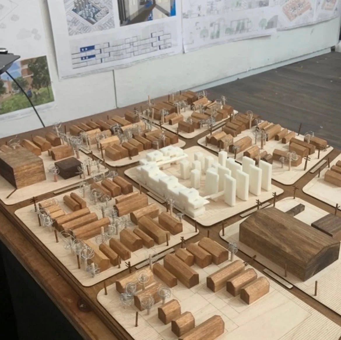 Architectural urban design model showing buildings, streets, and infrastructure within a larger site plan.