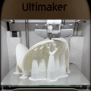 3D printer fabricating a physical architectural roof model.