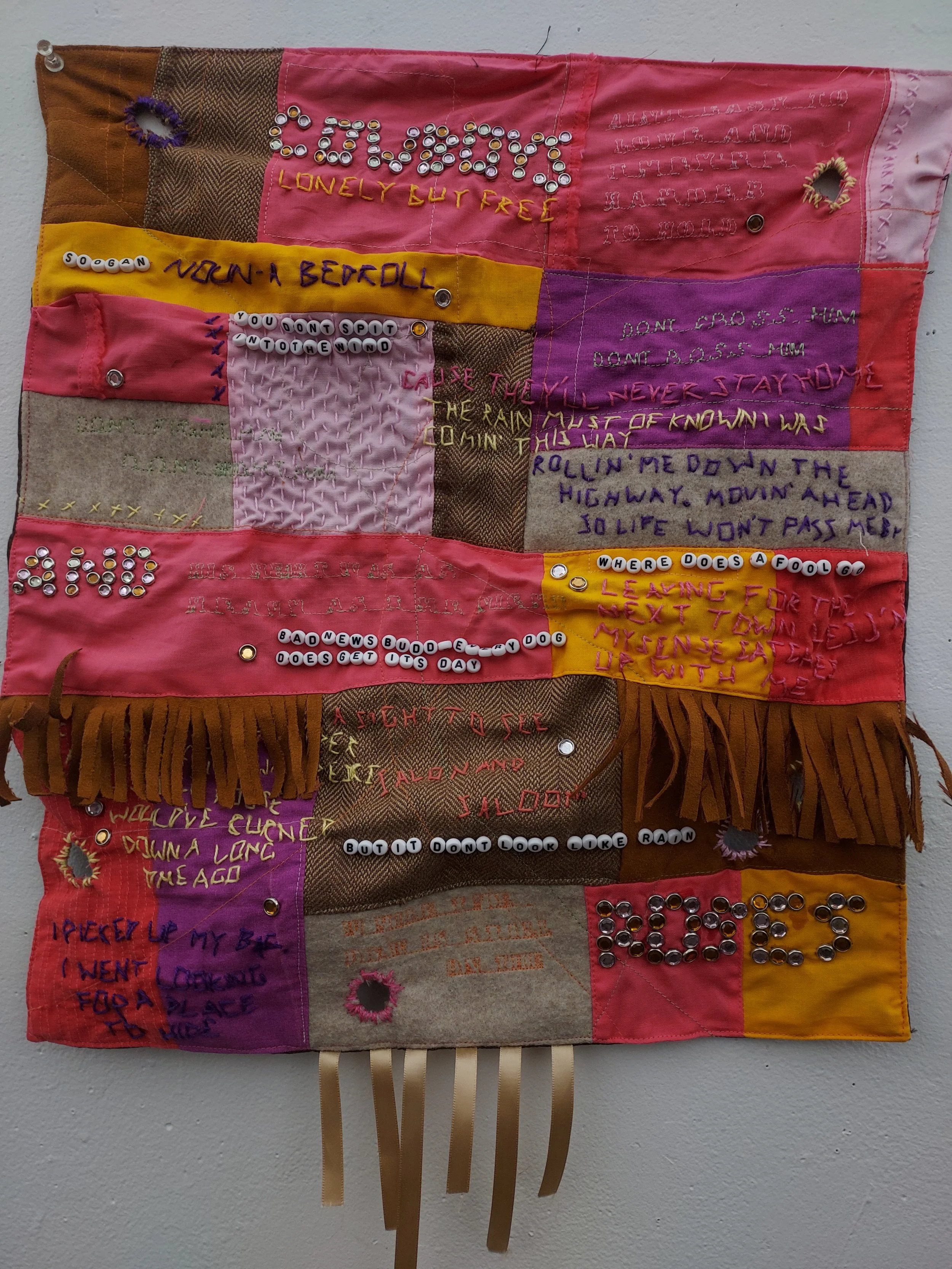 "Soogan 3. A SONGan if you will".
Found textiles, embroidery floss, letter beads, rhinestones, and ribbon.
2024