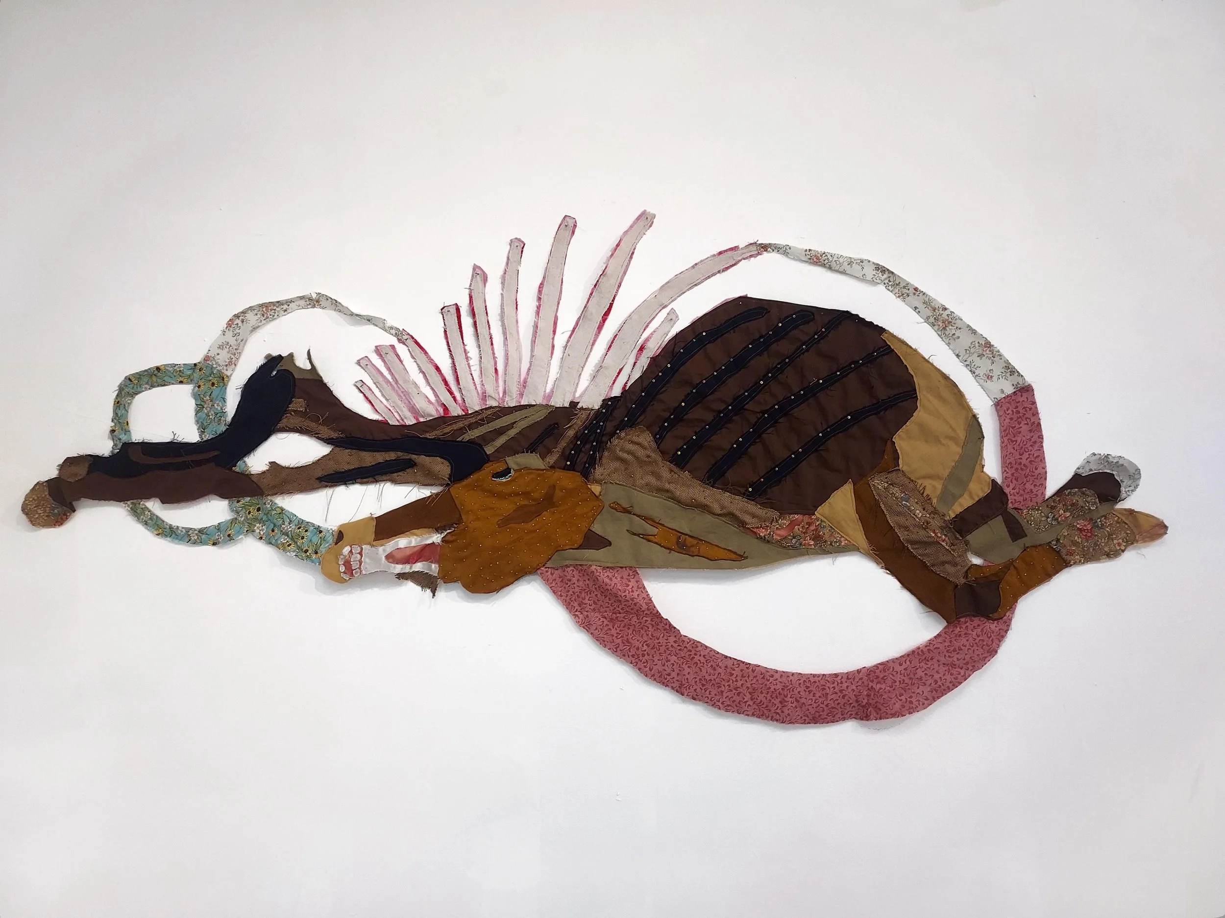 "Soogan 6. This one stinks".
Found textiles and glass beads.
2024.