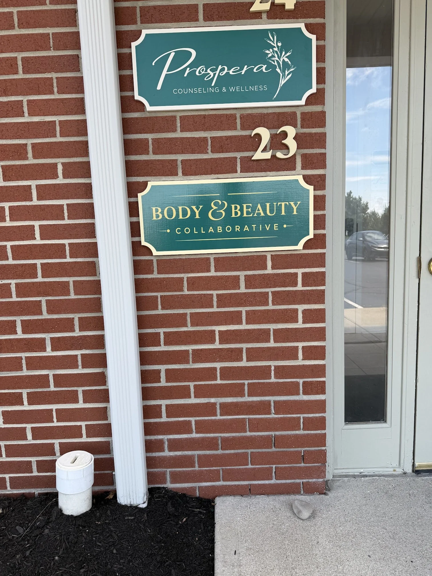 This is the visual you will see when at the correct entry point when trying to find The Purple Wax Suite. Located in suite 23 on the first floor. Walking in this door, there will be another door with The Purple Wax Suite logo.