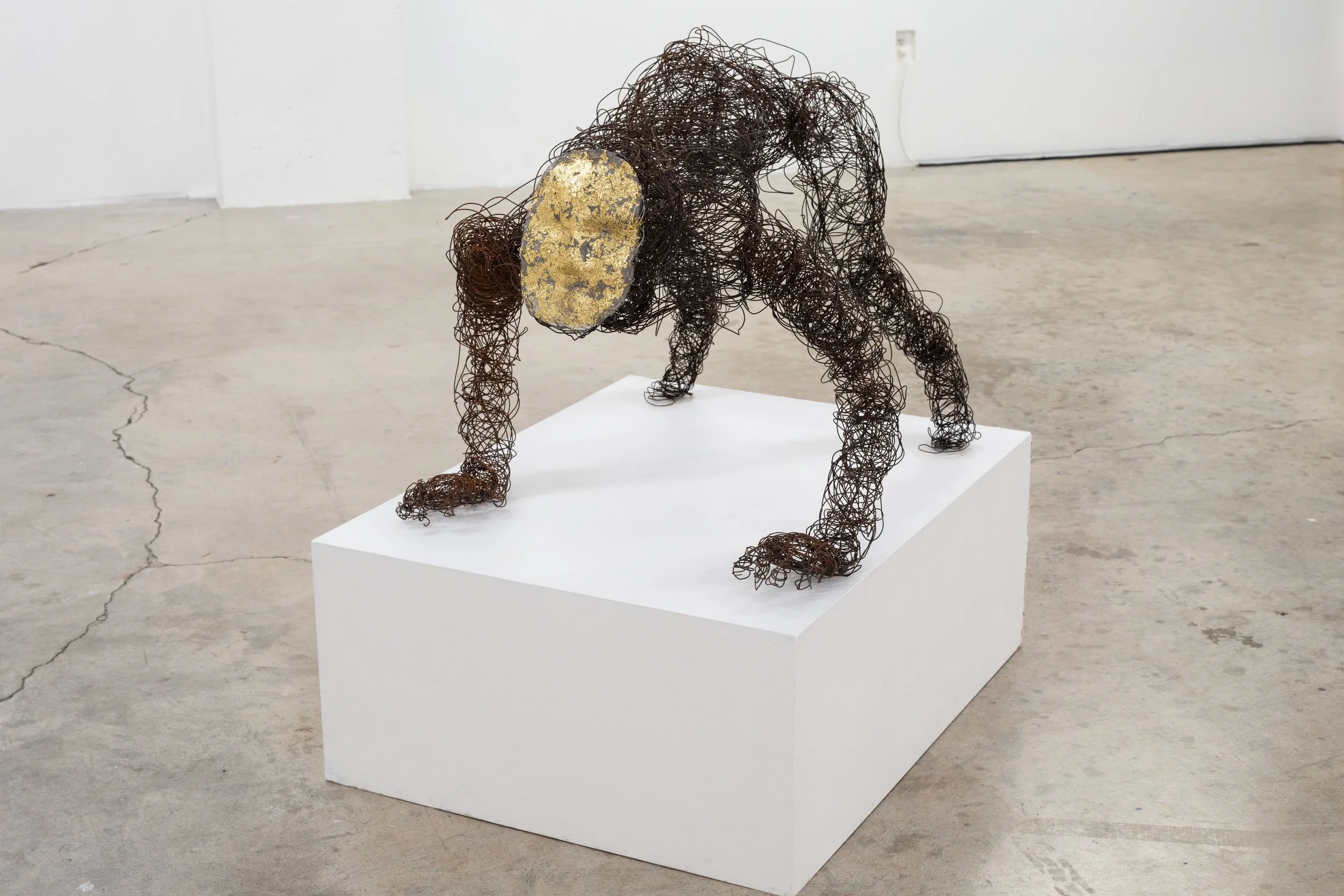 Crawling, 2025, 52" x 30" x 42", rusted wire, gold leaf, mesh
