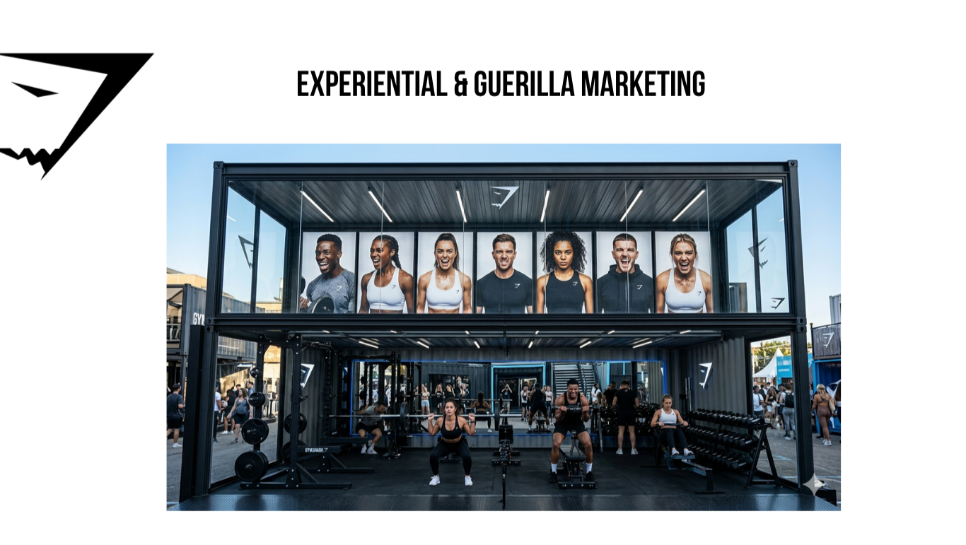 An outdoor fitness event with a two-story container structure. The upper level displays large photos of diverse, smiling people. The lower level has people working out with gym equipment, including weights and benches.