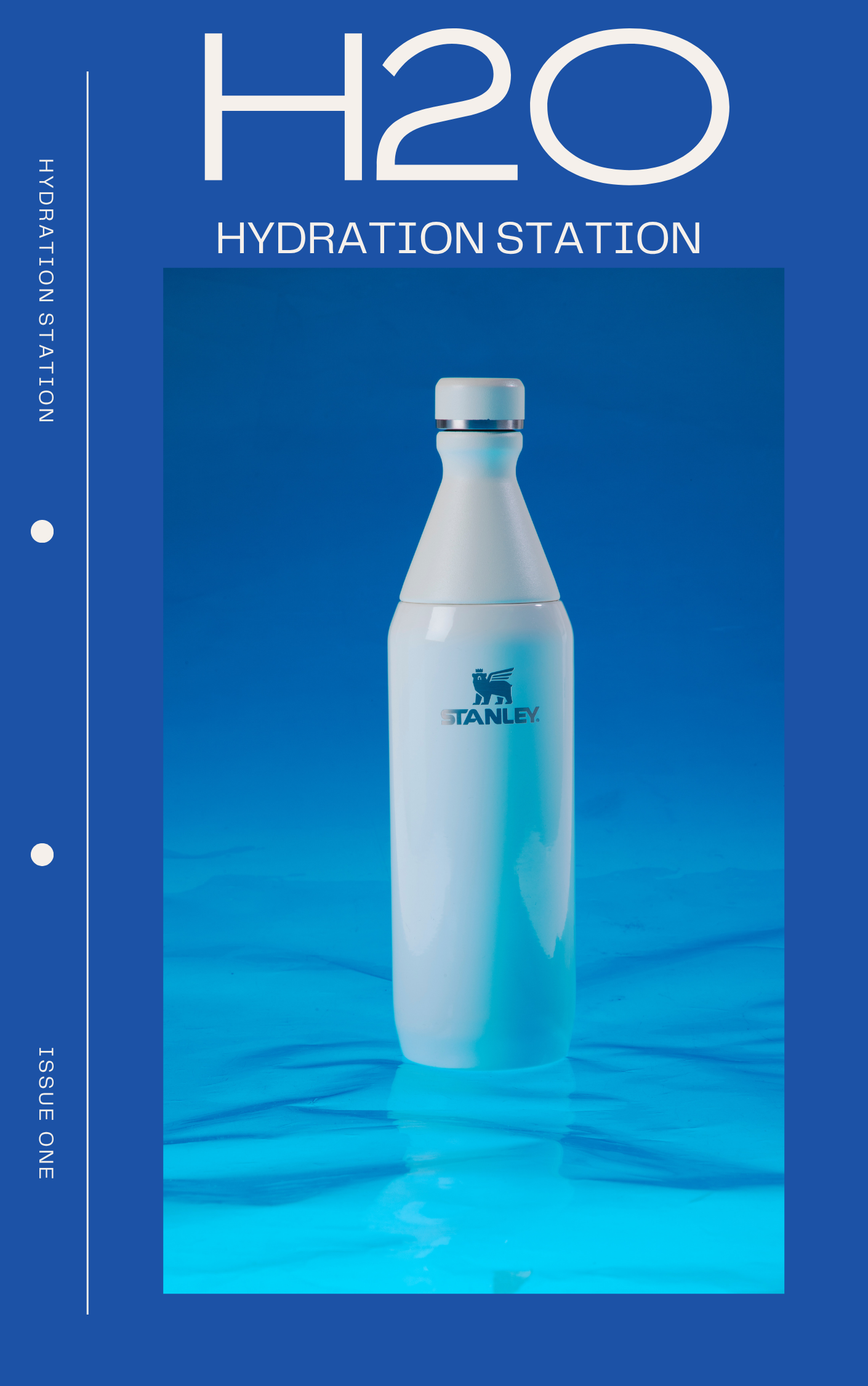 A white water bottle with the Stanley logo on a blue background
