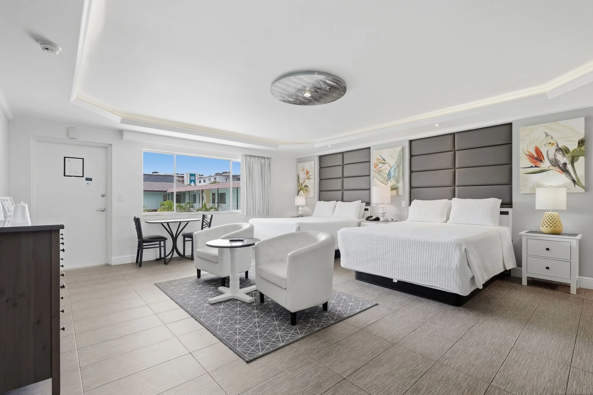 Studio suite with two beds, sitting area and dining table at Island House Resort Hotel