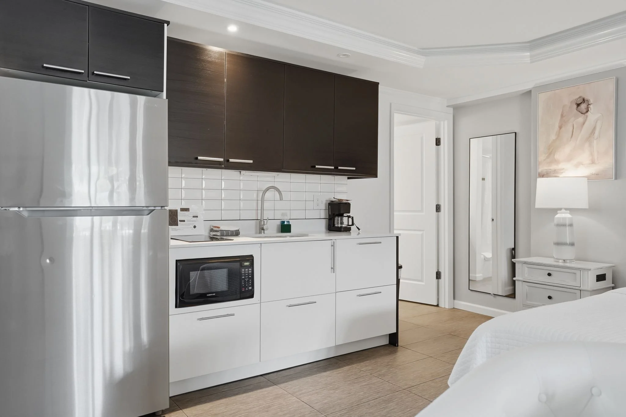 In-room kitchenette with full-size refrigerator, microwave, cooktop and coffee maker