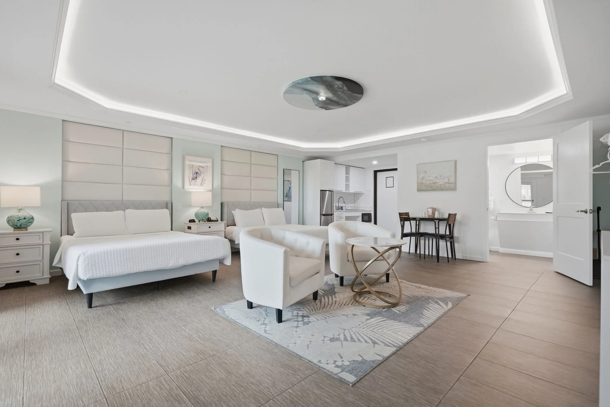 Two queen beds with upholstered headboards and heron artwork in an ADA Double Queen room